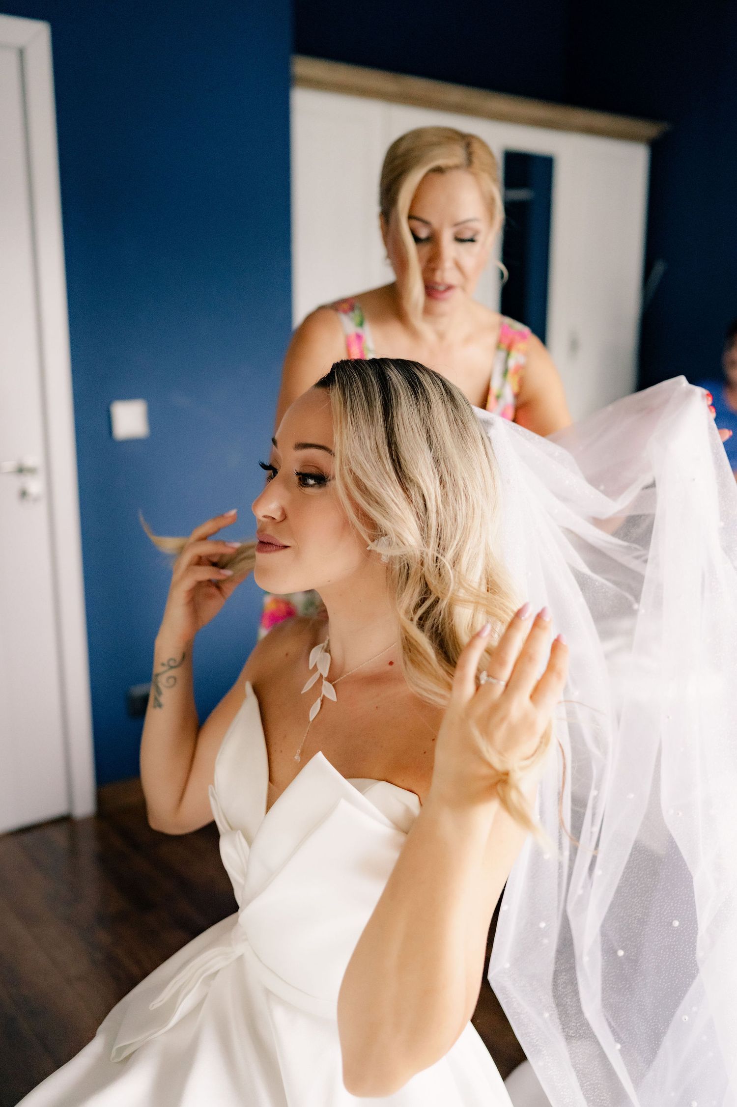A series of photos showing a bride in white dress and veil getting ready before her wedding ceremony.