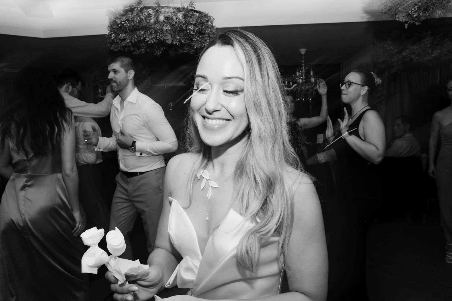 Black and white photos show people dancing and socializing at what appears to be a wedding reception or party.