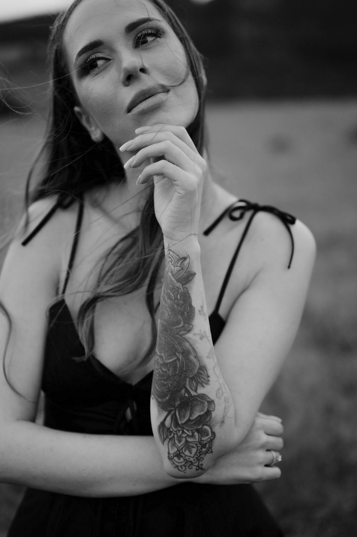 Black and white portrait series showing artistic poses with visible tattoo art.