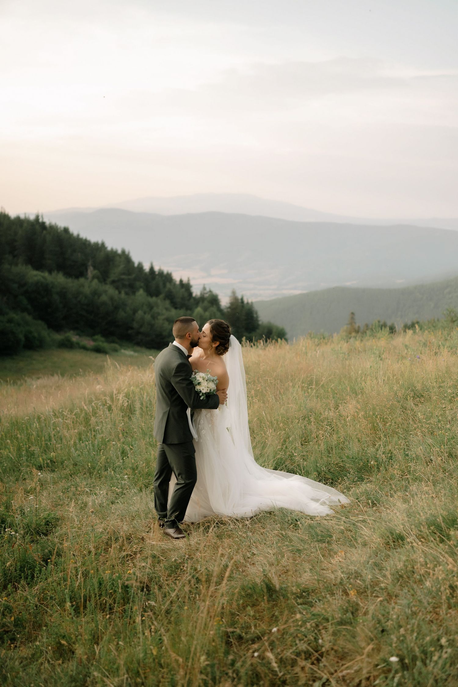 A romantic wedding photo sequence showing a couple embracing in a mountain meadow with rolling hills in the background.