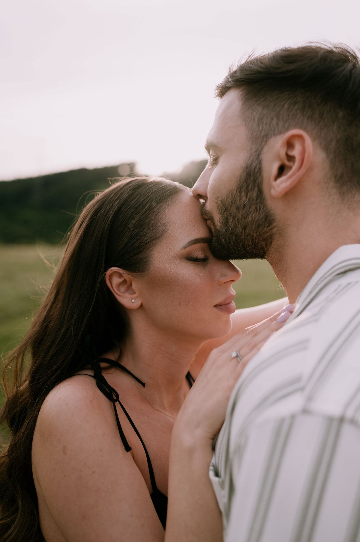 A romantic couple in white clothing sharing intimate kisses in a series of connected photos outdoors.
