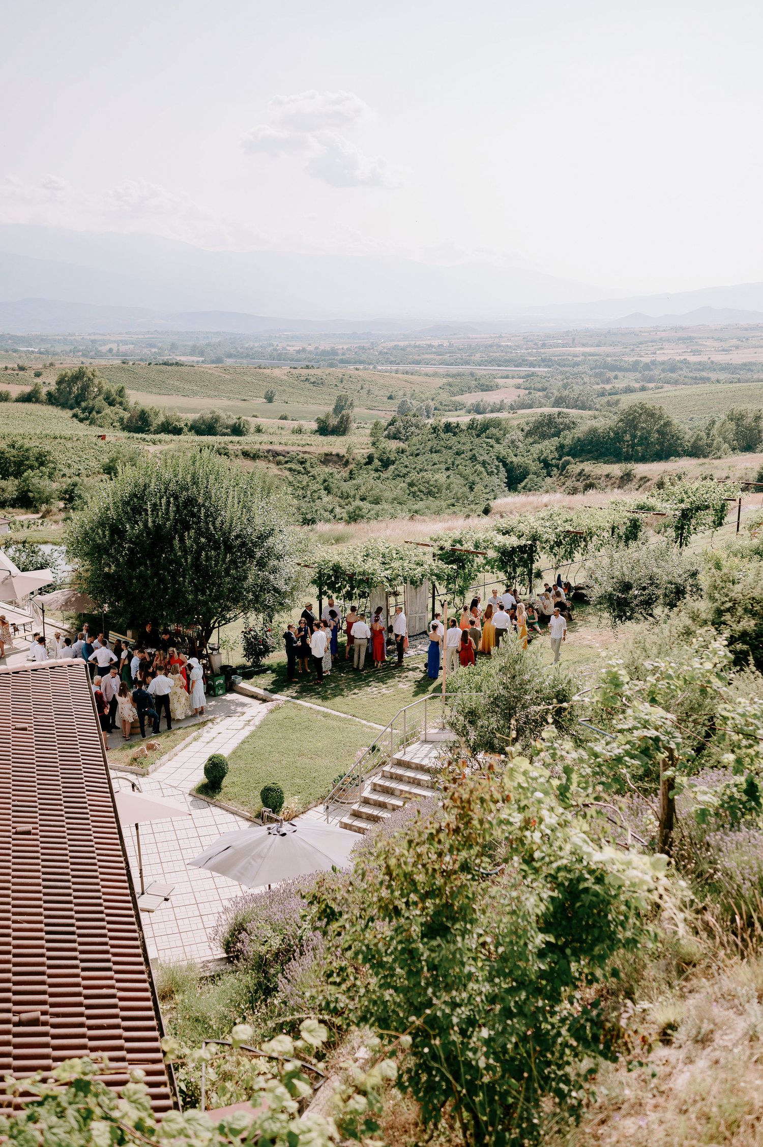 Panoramic view of an outdoor wedding venue with stone steps and scenic mountain landscape.