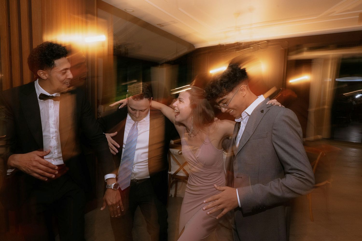 Wedding reception dance floor with guests celebrating in motion blur.
