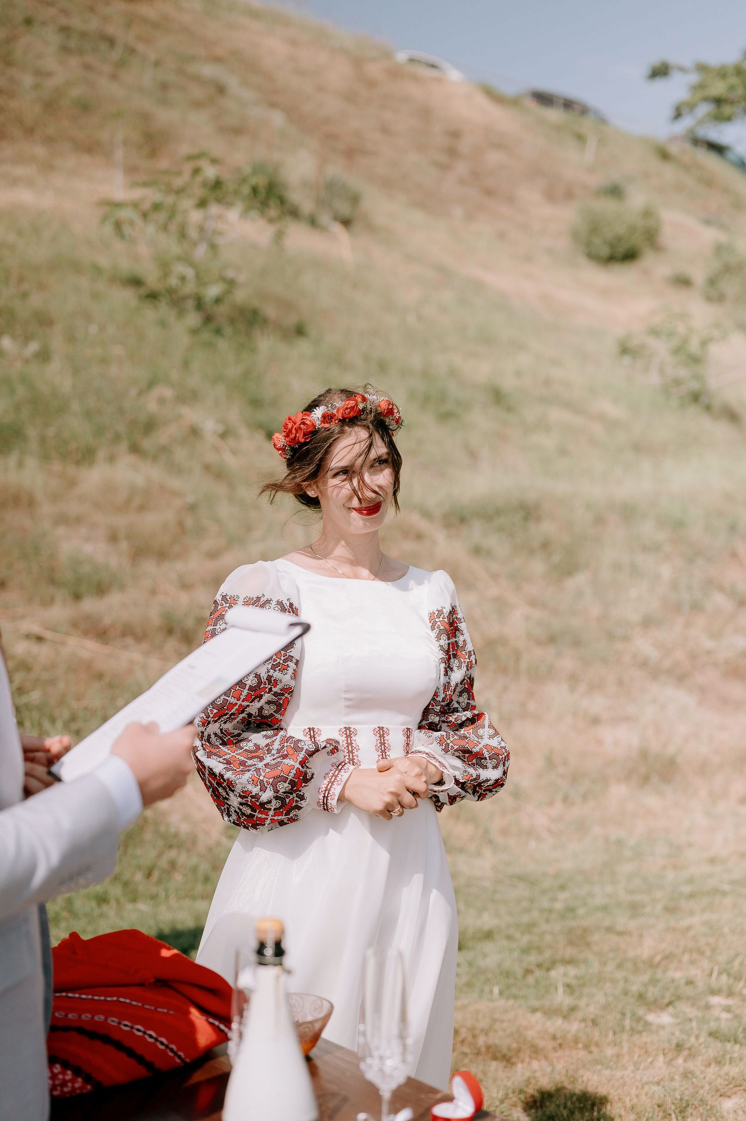 Traditional white dress with embroidered details being displayed outdoors.