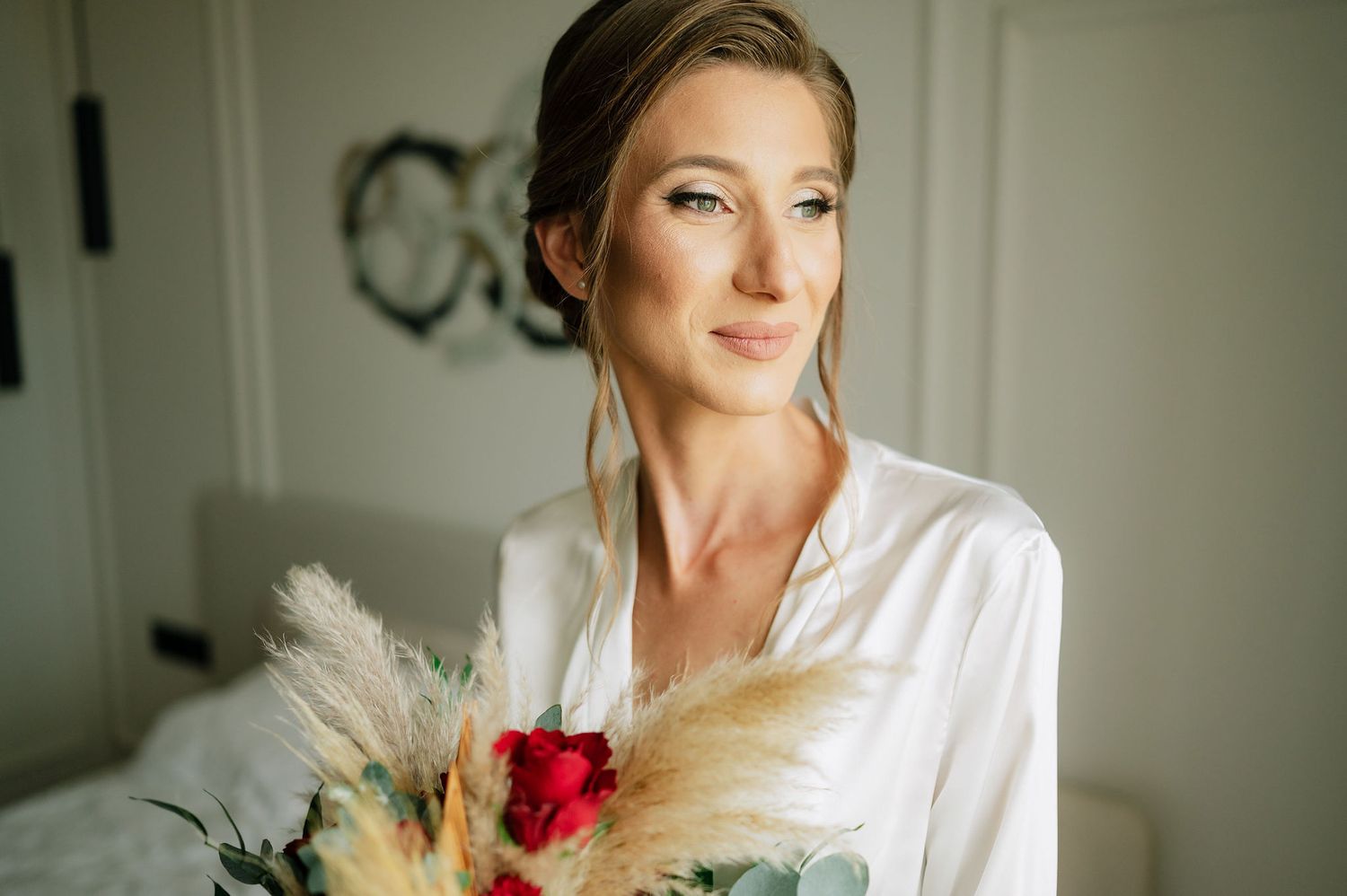 Soft natural light illuminates bridal preparations with elegant bouquet details.