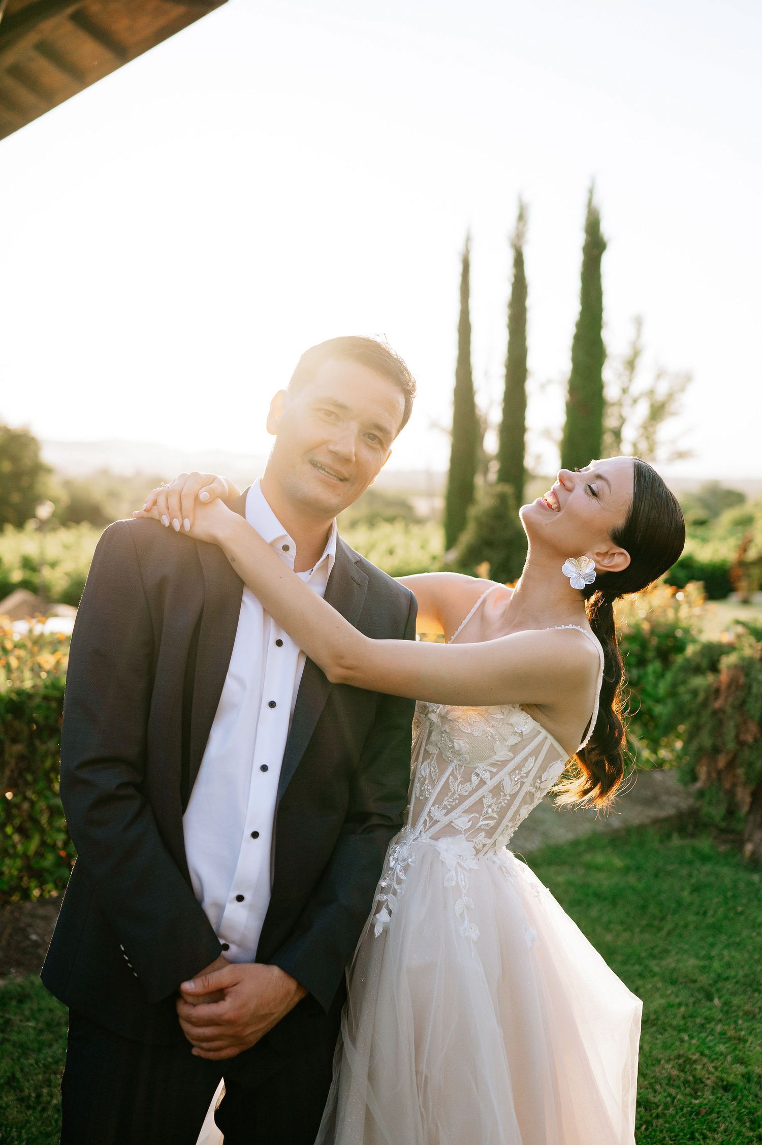 Couple sharing playful dance moment during sunset wedding photography session.