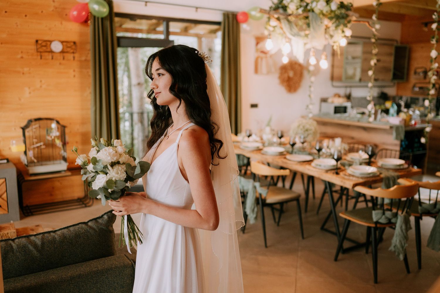A rustic wedding reception venue features warm wood walls and romantic string light decorations.