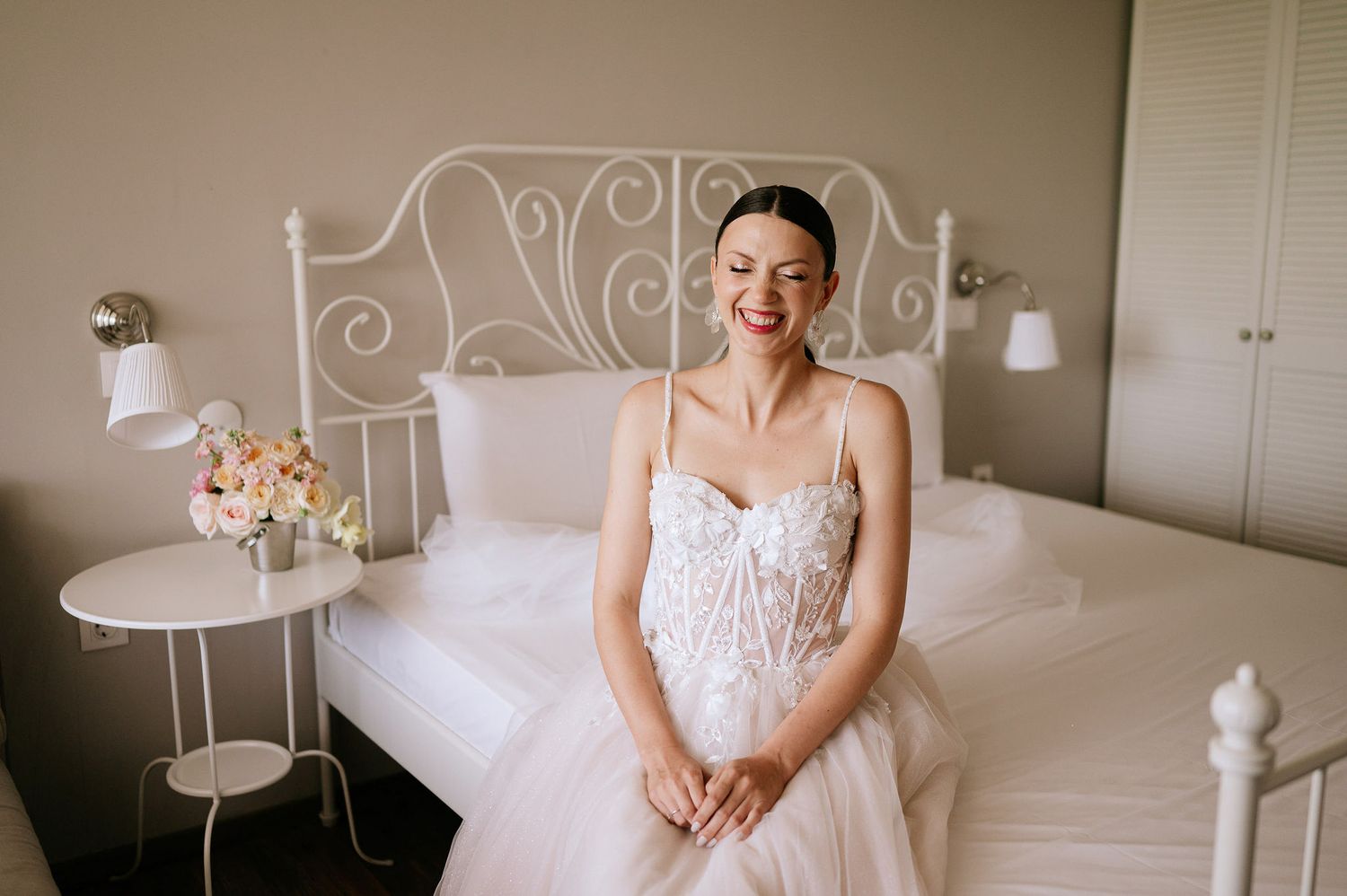 Intimate bridal portrait highlighting delicate lace details of white wedding gown.