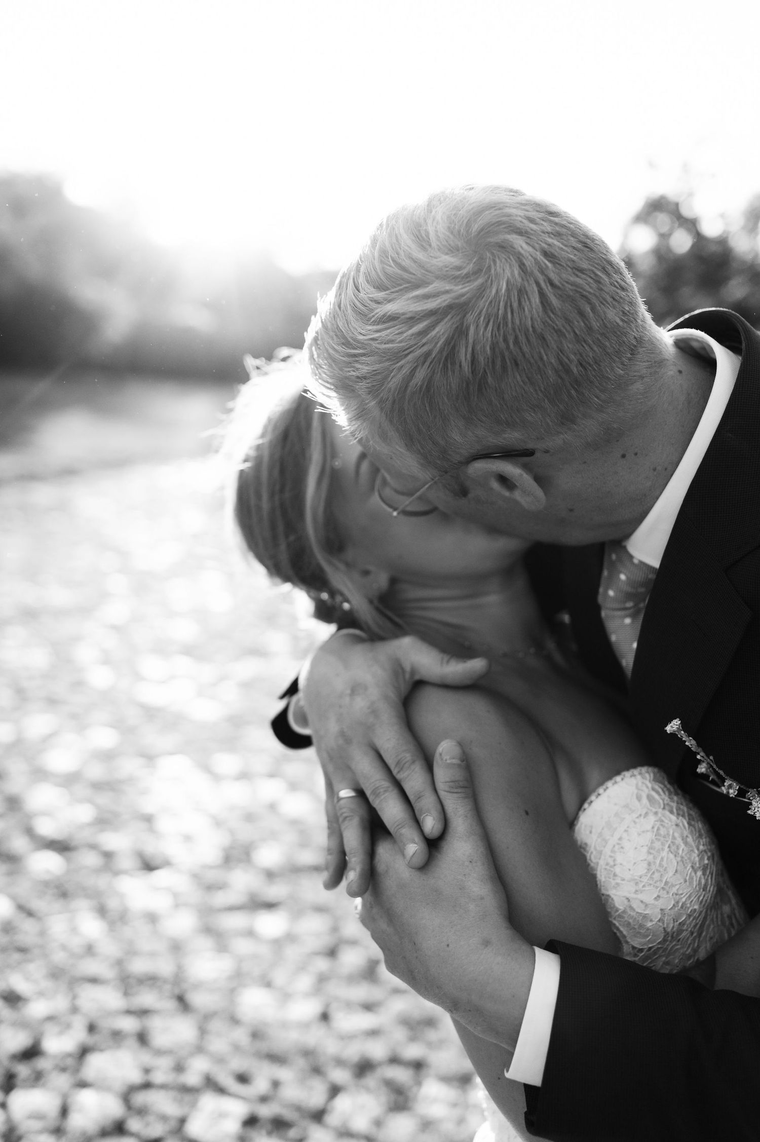 A black and white capture of an intimate wedding moment on cobblestones.