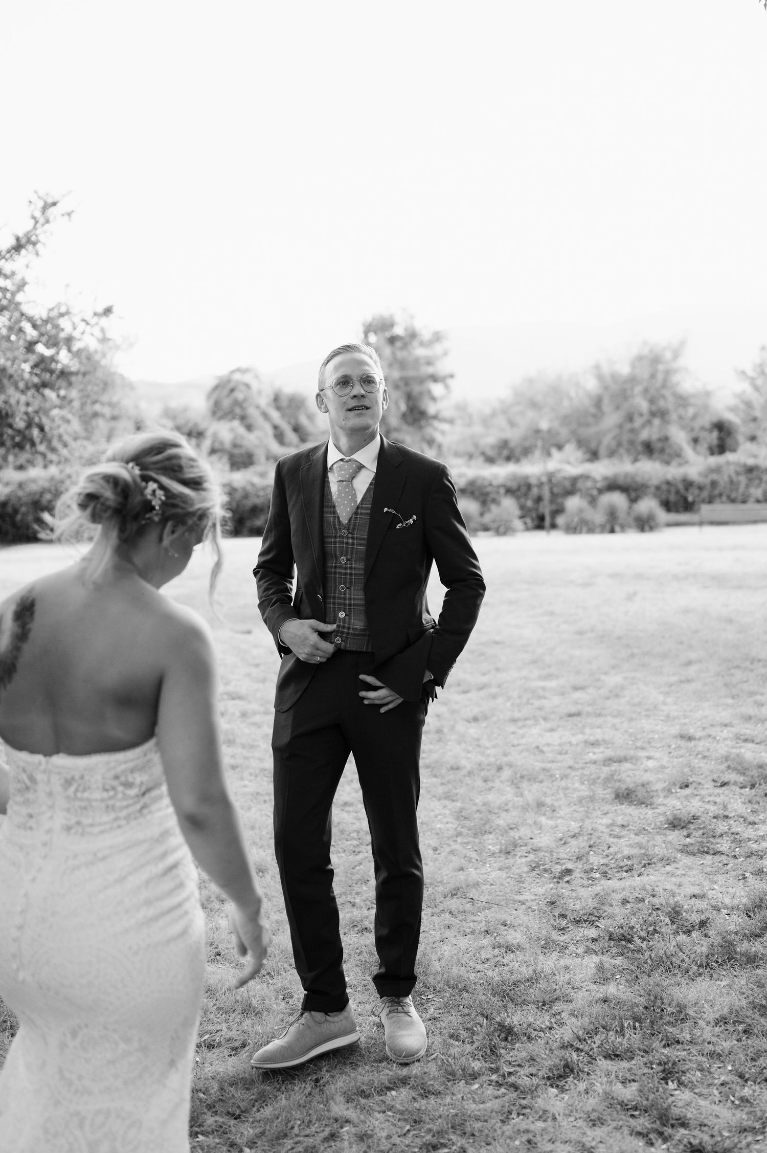 Black and white wedding portraits captured in outdoor garden setting.