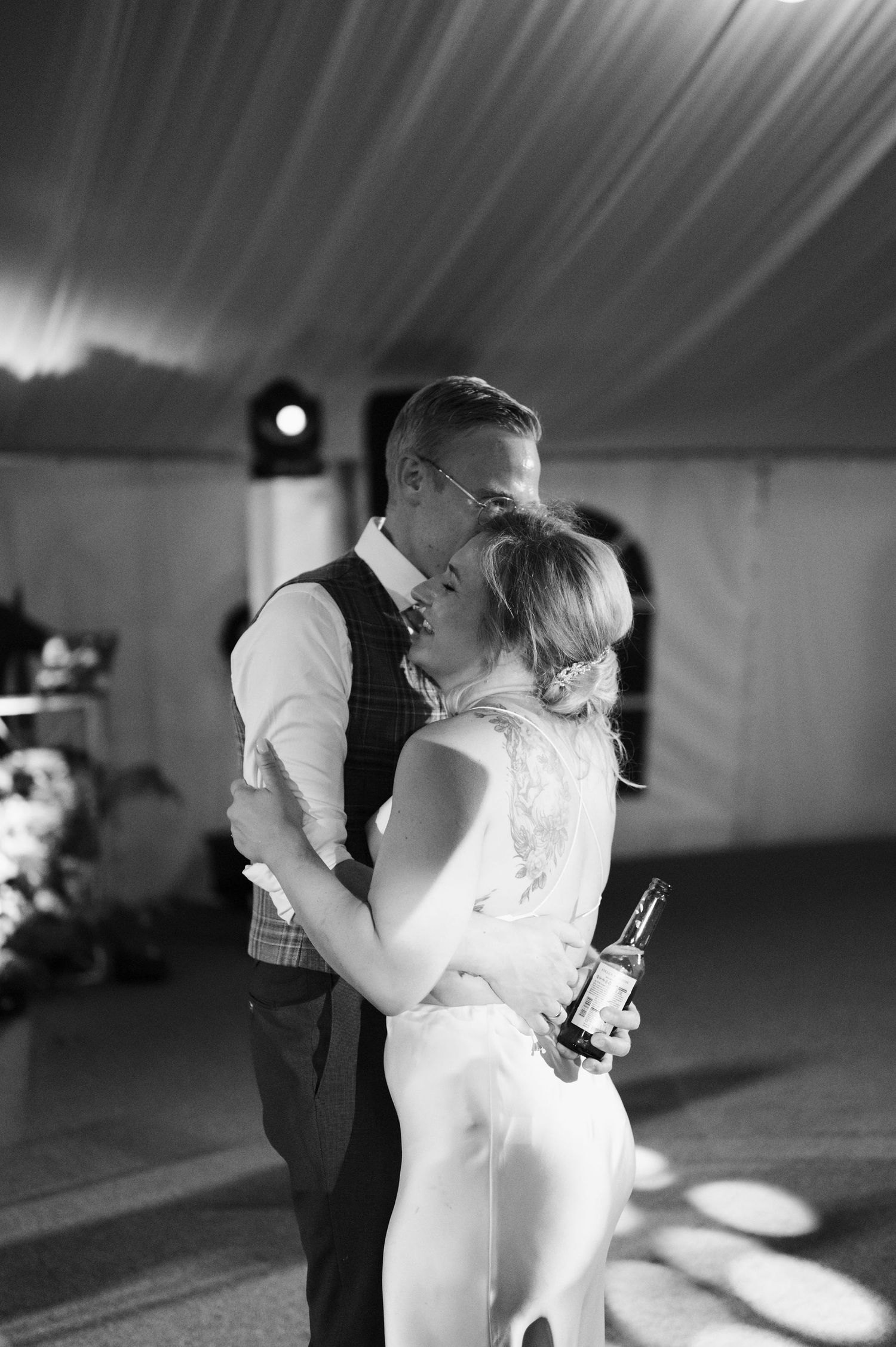 Black and white wedding dance sequence showing tender moments between a couple in an elegant venue.