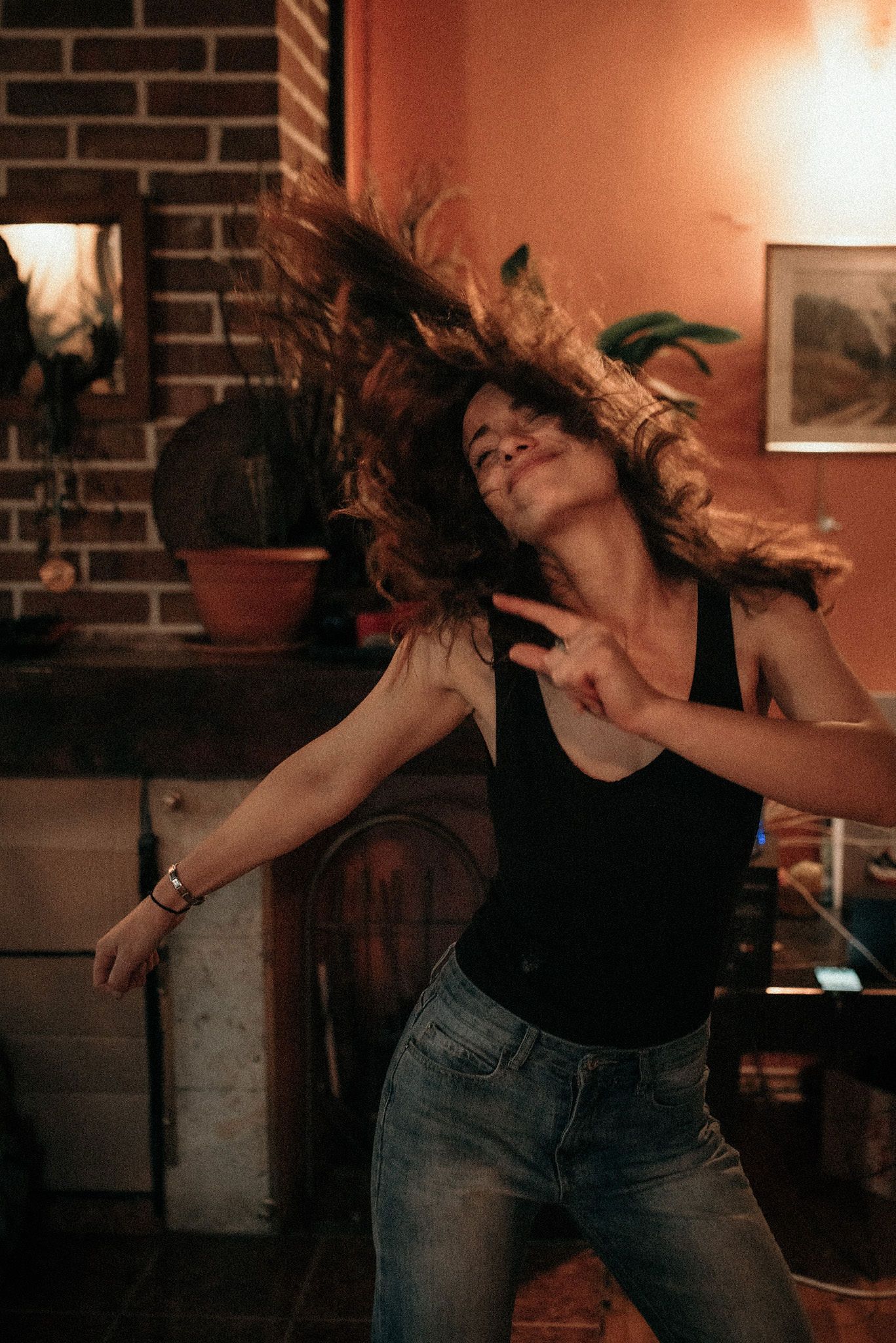 A sequence of dance movement photos showing a person in jeans and black top performing expressive dance poses.