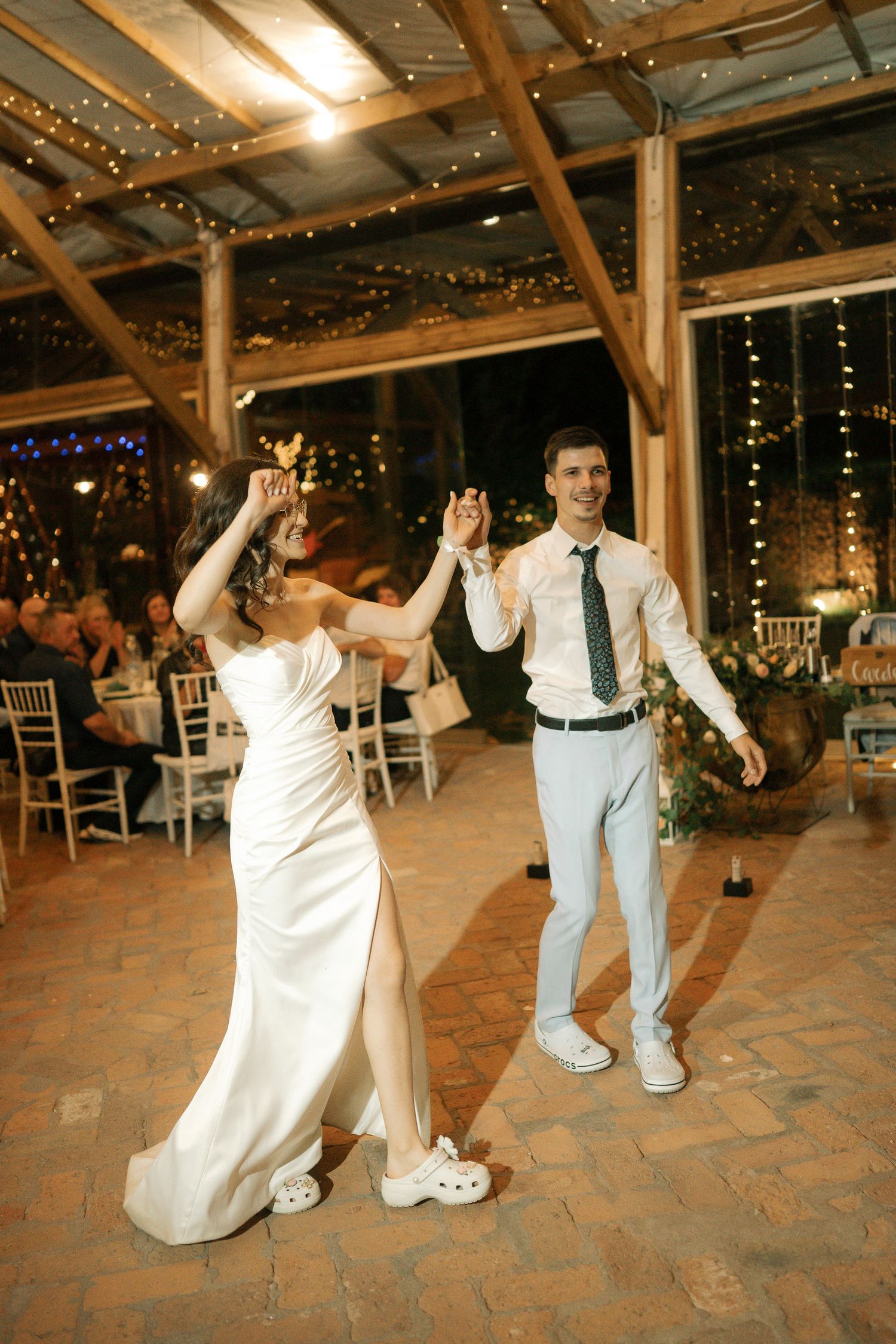 A sequence of dance moves at a wedding reception shows a couple performing on a tiled floor under string lights.