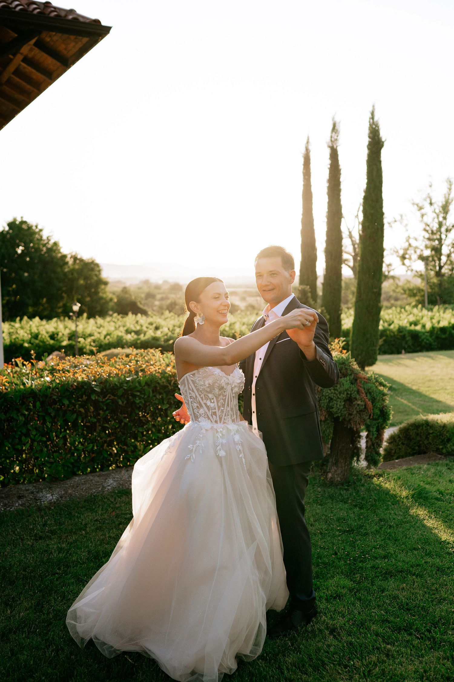 Playful wedding dance sequence captured in a Mediterranean garden setting at dusk.