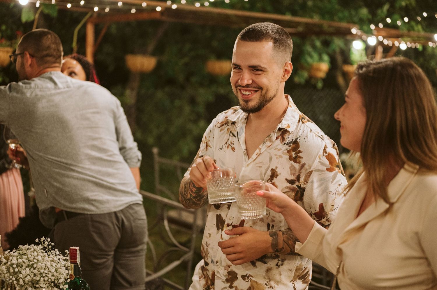 Intimate wedding reception scene with warm lighting and natural decor elements.