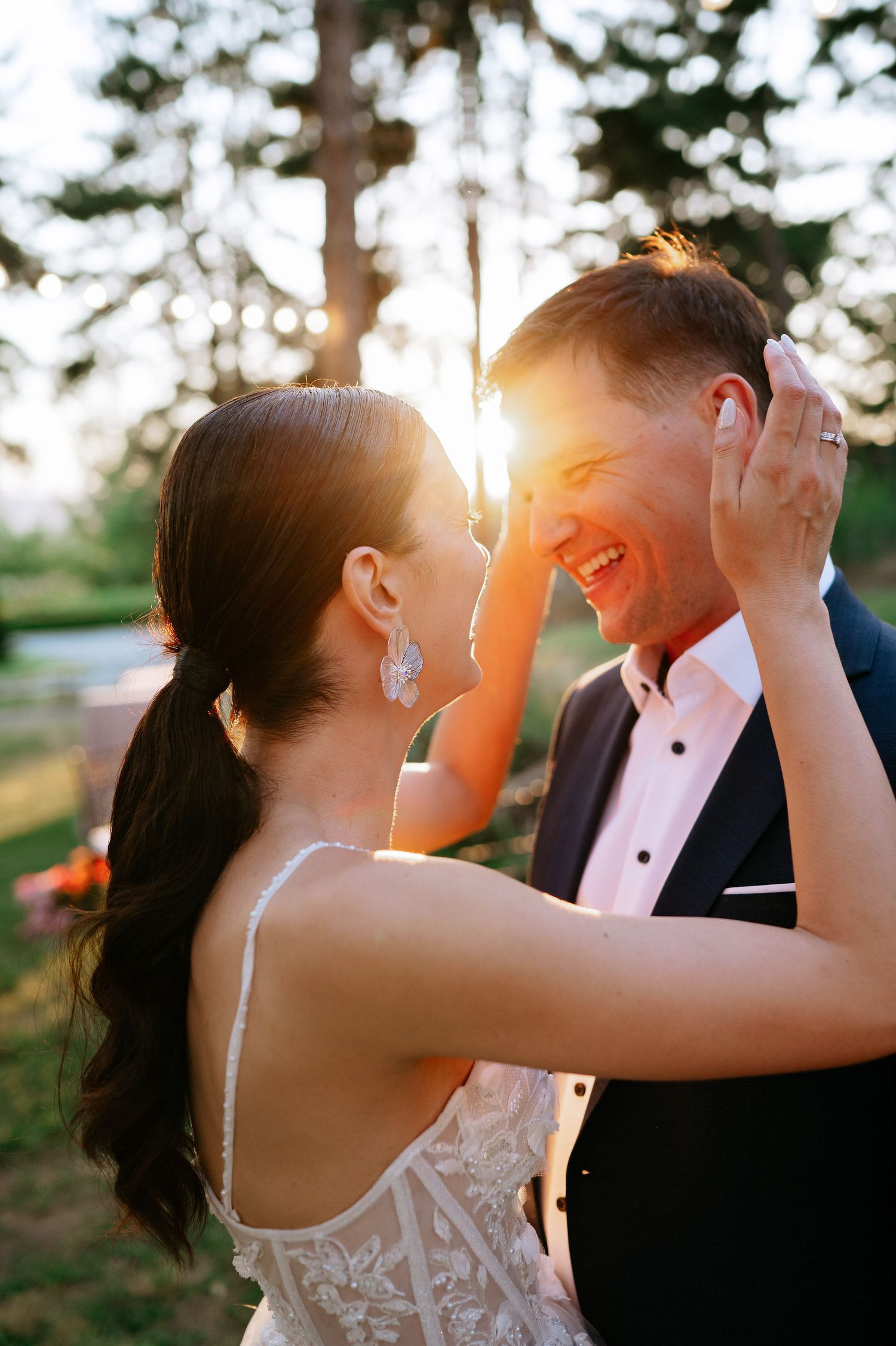 Golden sunlight illuminates tender moments between newlyweds during sunset portraits.