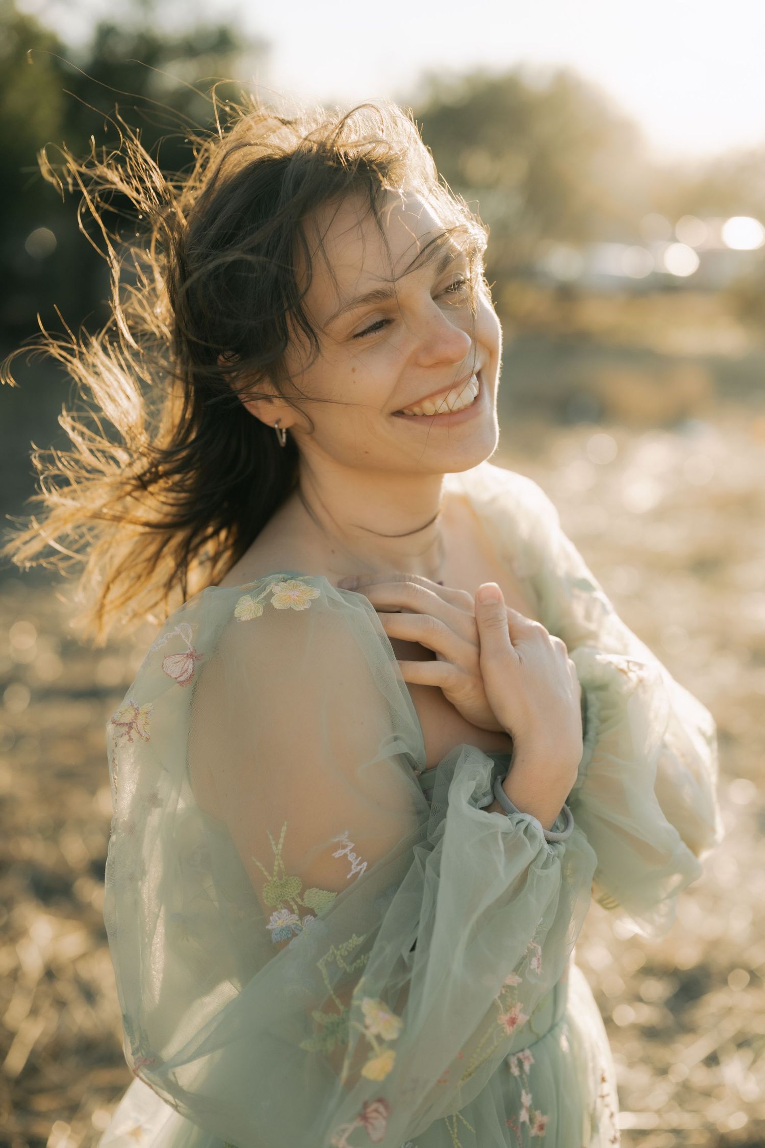 A dreamy portrait series of someone in a mint green dress with flowing hair captured in warm golden sunlight.