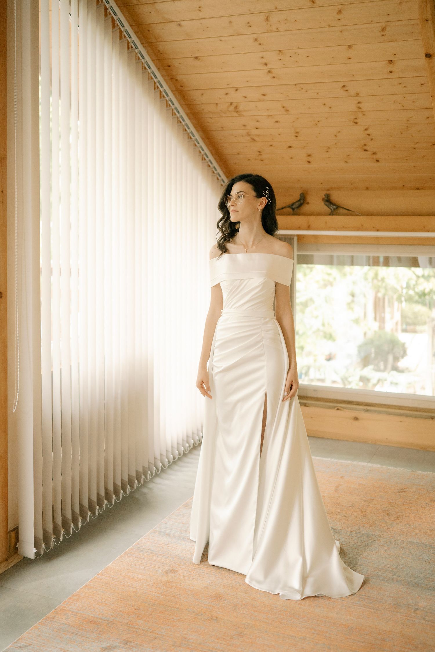 Multiple views of a white wedding gown photographed in sequence against wooden walls and natural lighting.