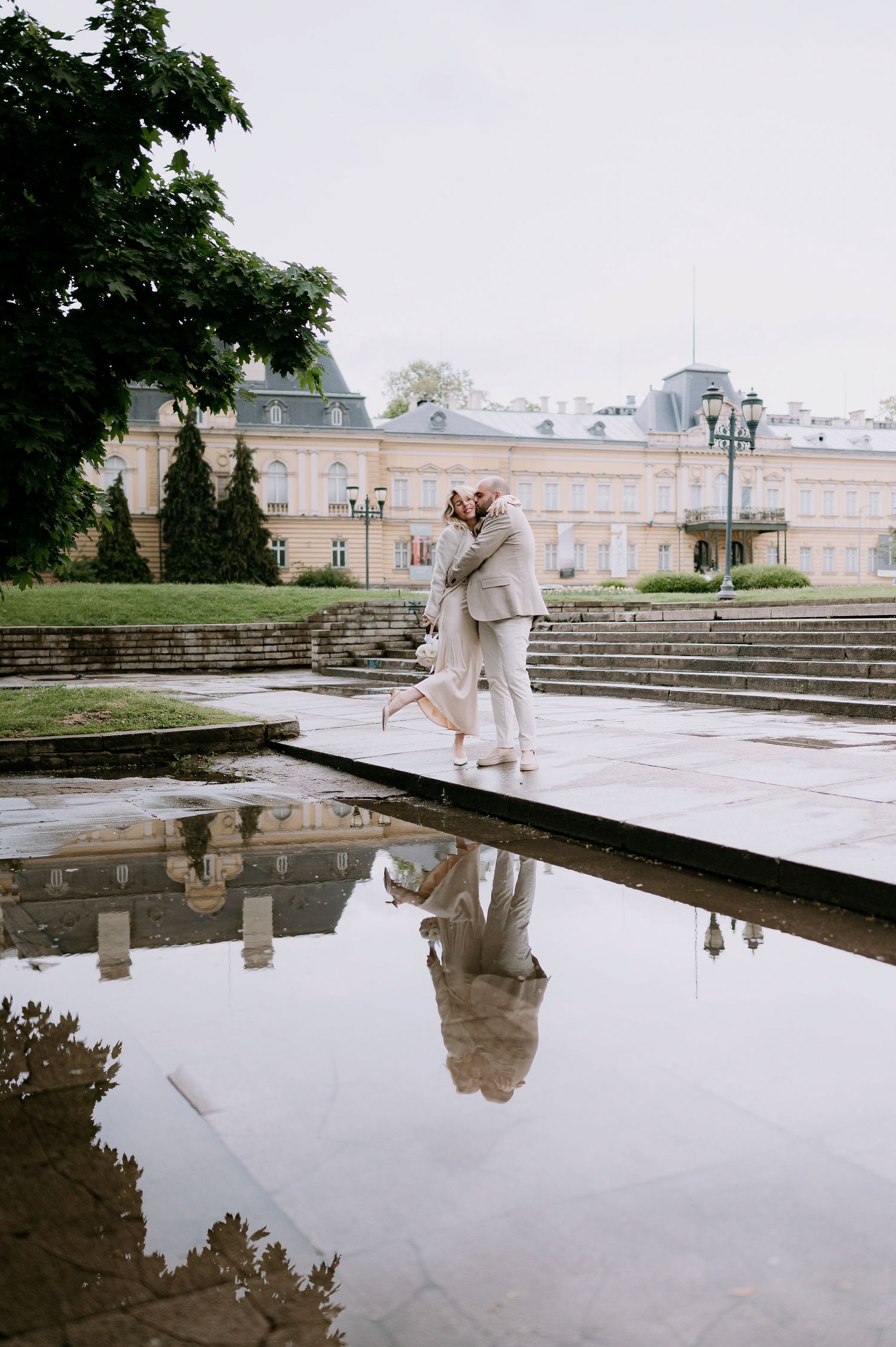 Romantic dance scene with palace architecture and reflective pool creating mirror effect.