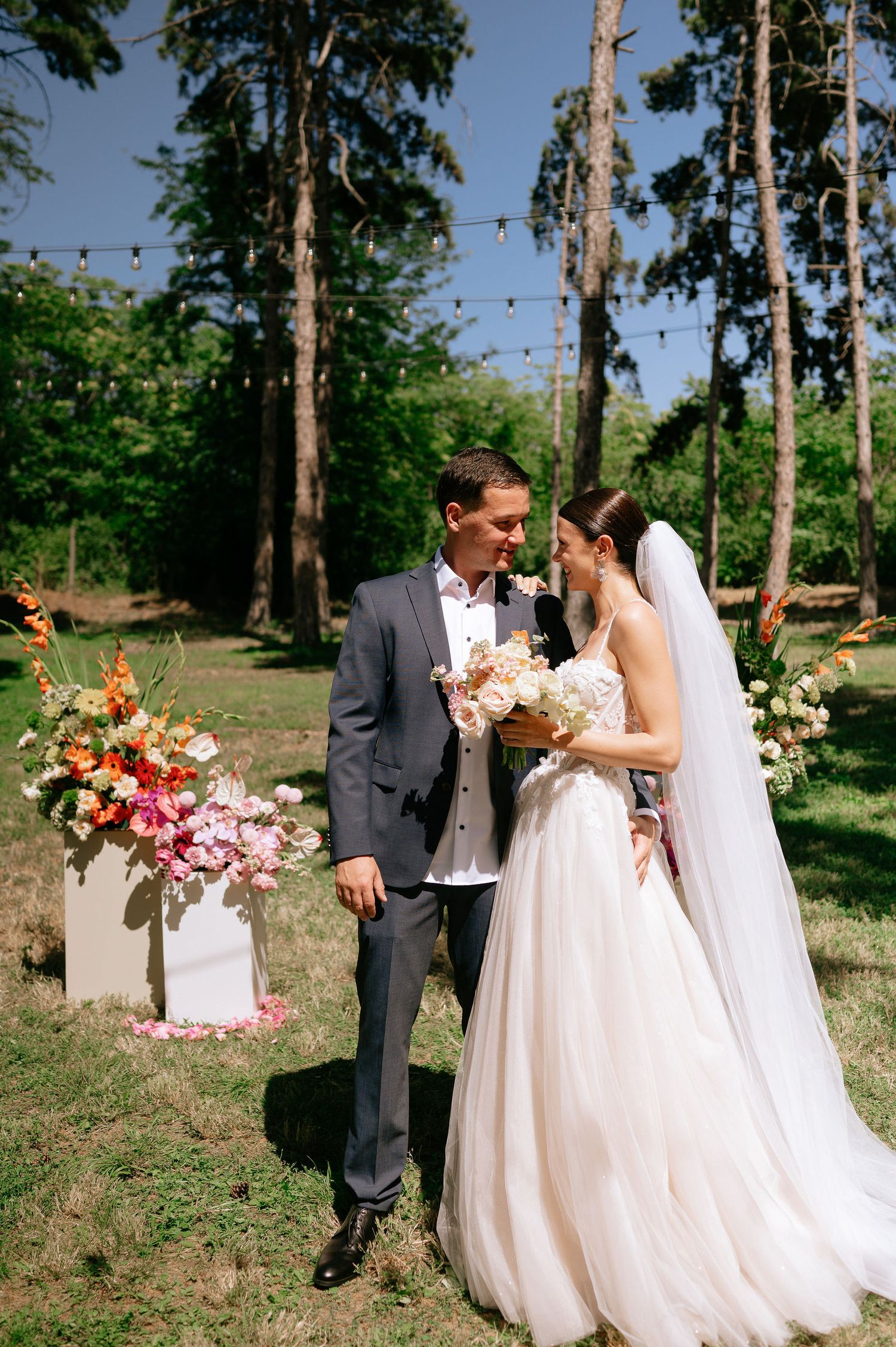 A wedding photo sequence showing a couple sharing sweet moments among tall trees in a natural setting.