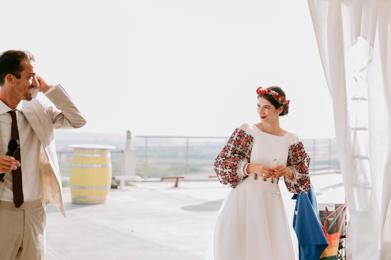 Wedding ceremony moments captured under a white tent with natural daylight streaming in.