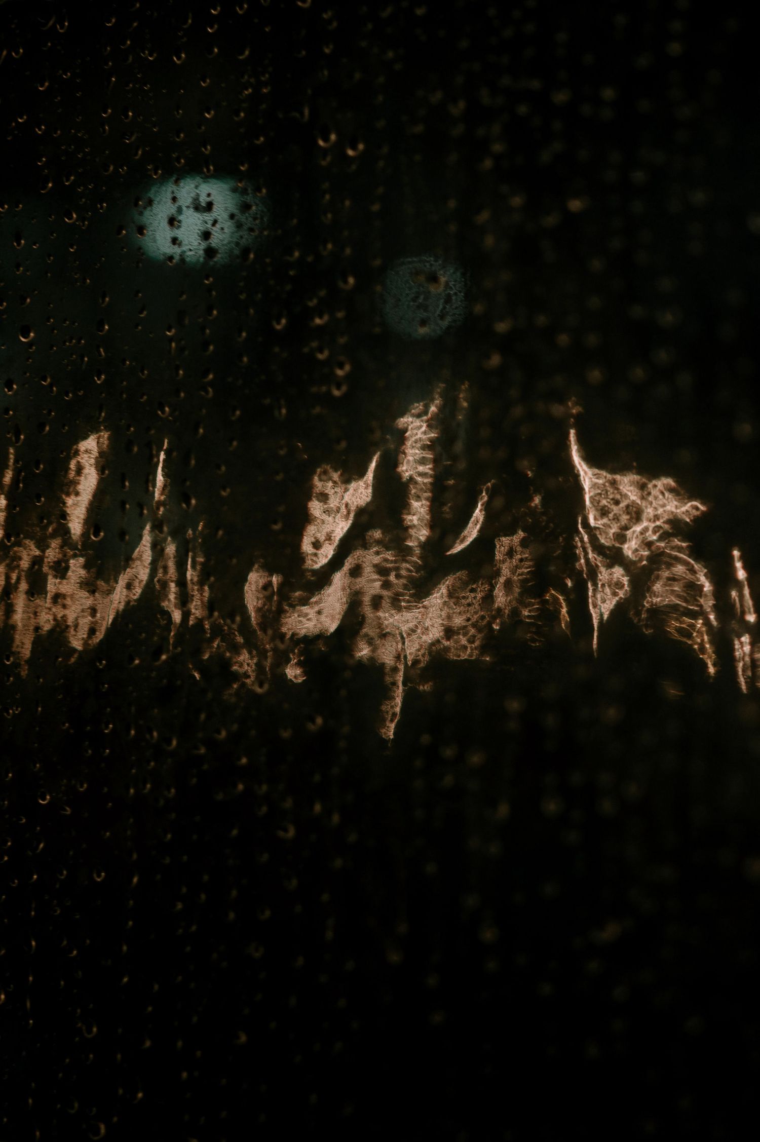Dark abstract background with textured patterns and light reflections creating a moody atmosphere.