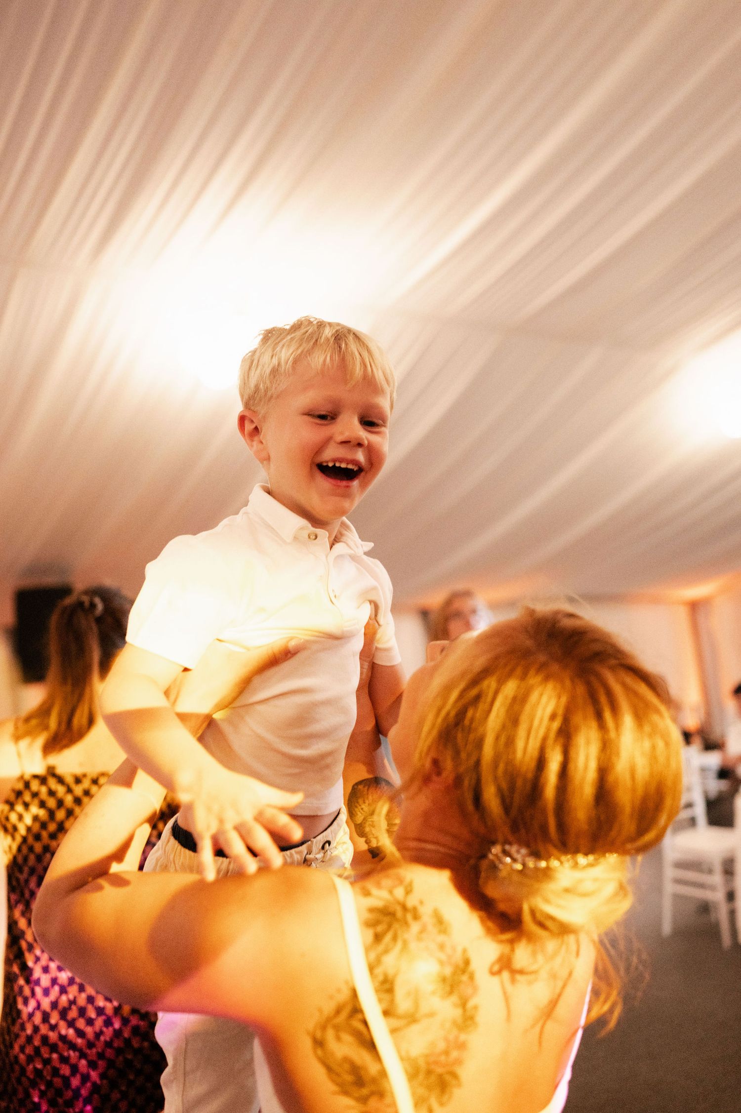 Playful dance moves captured during wedding reception celebration.