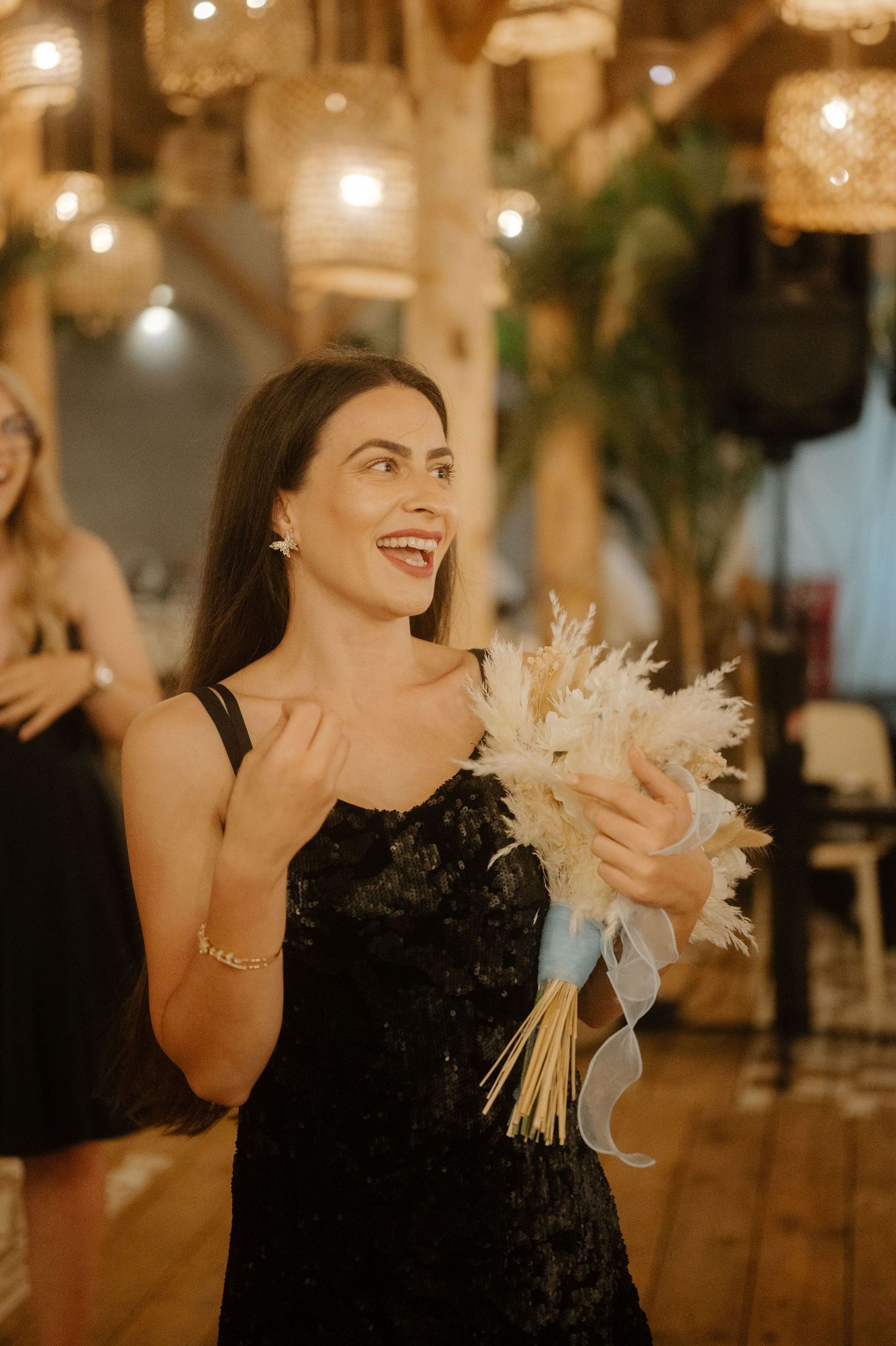A sequence of photos shows someone in a black dress laughing and dancing at an indoor event with warm lighting.