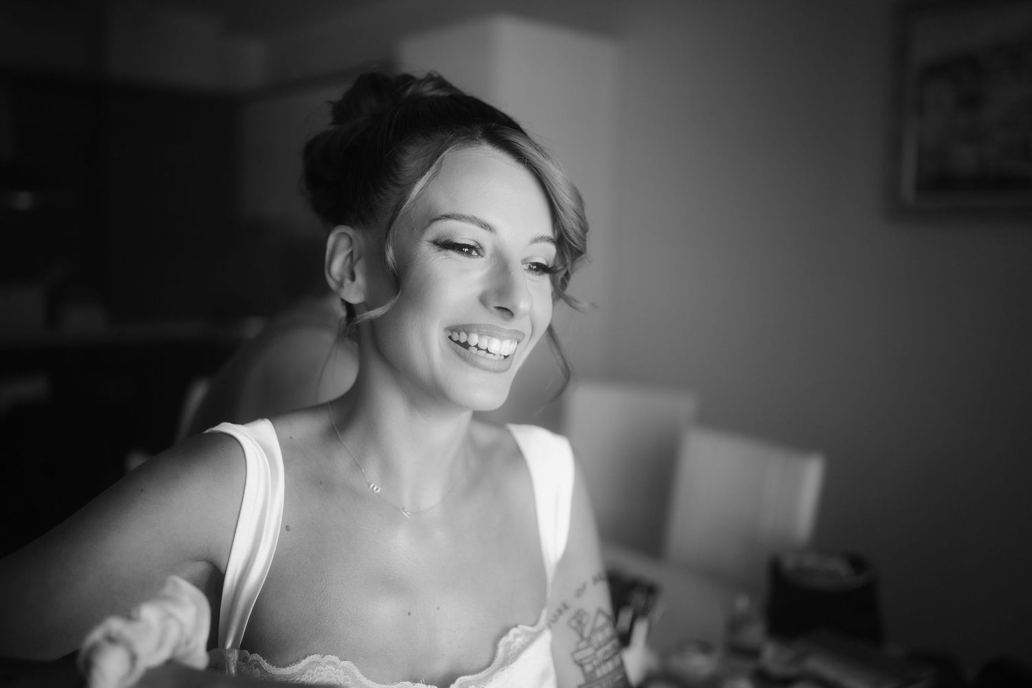 Series of candid black and white photos capturing joyful moments during bridal preparations.