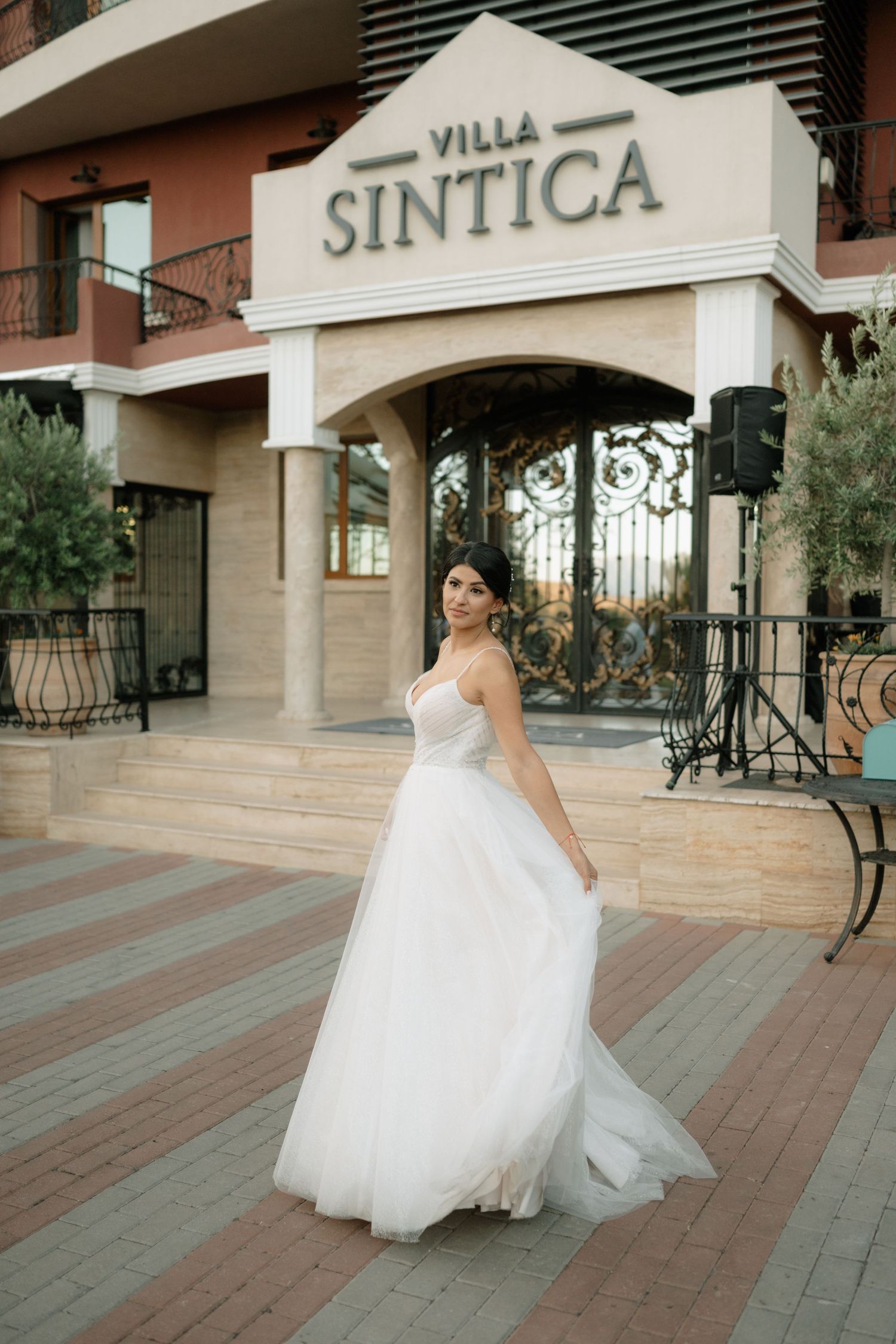 A bride in a flowing white ballgown twirls gracefully outside Villa Sintica in a series of connected photos.