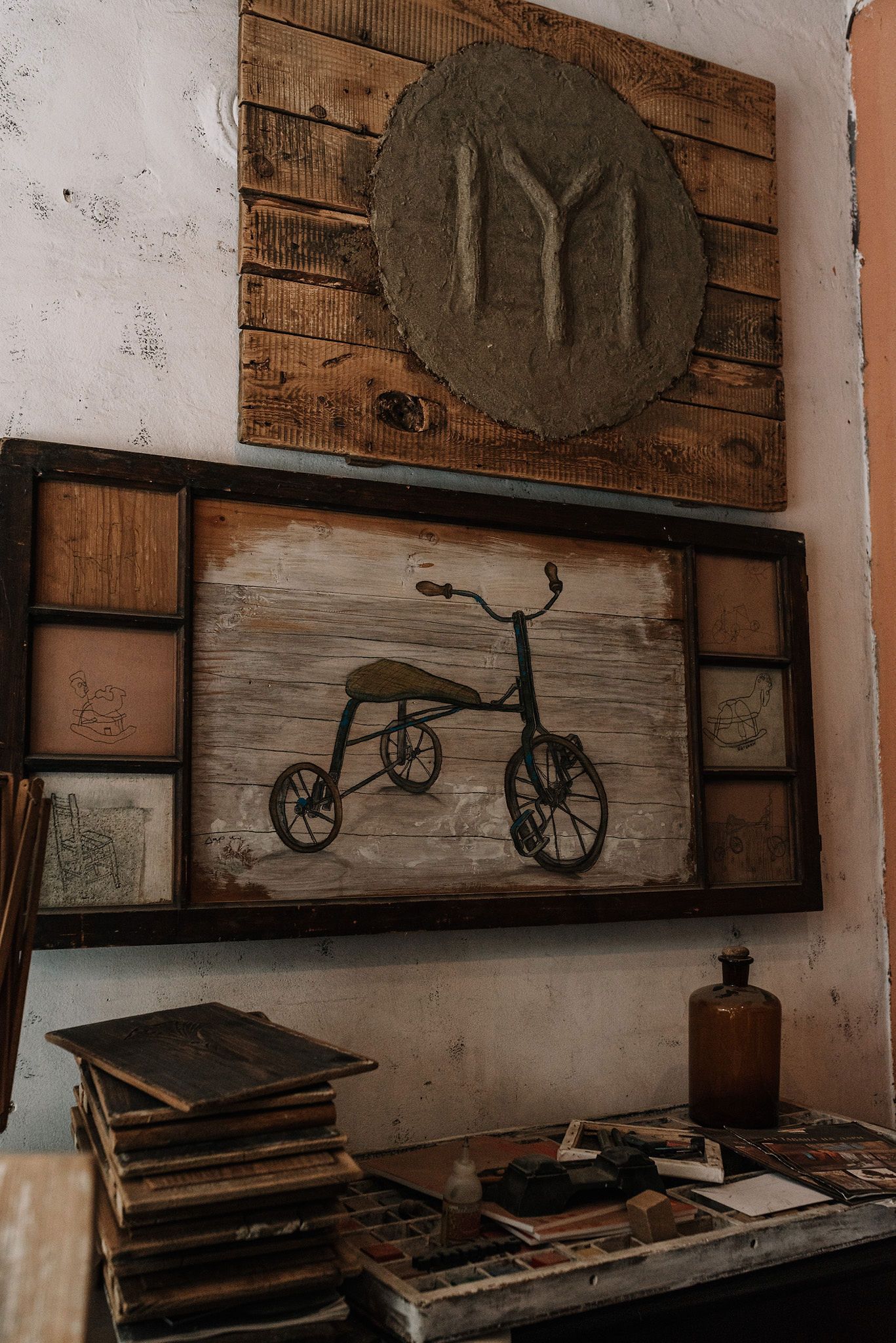 Vintage wall display featuring bicycle artwork and circular decorative elements.