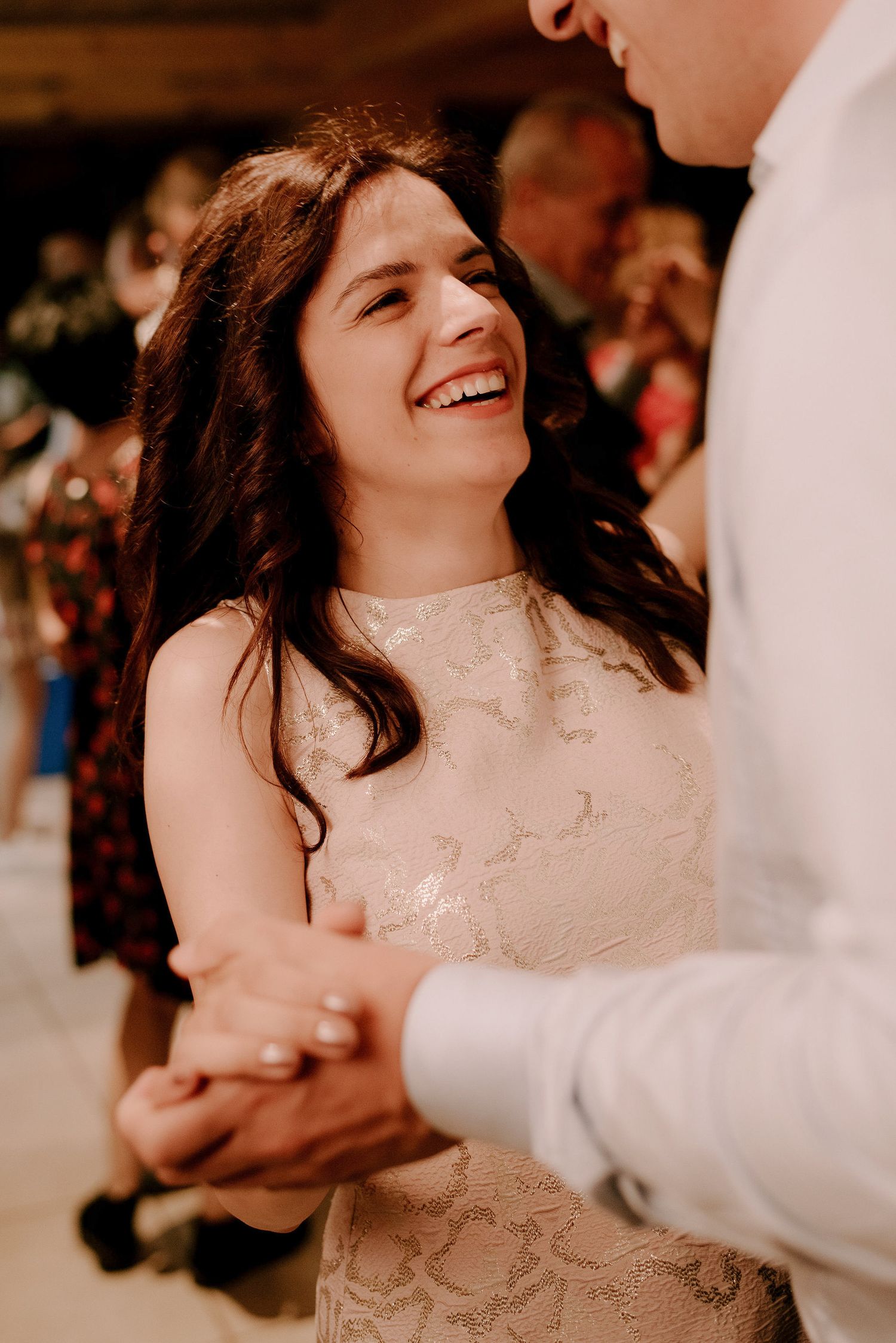 Couple sharing a joyful dance moment at their wedding reception.