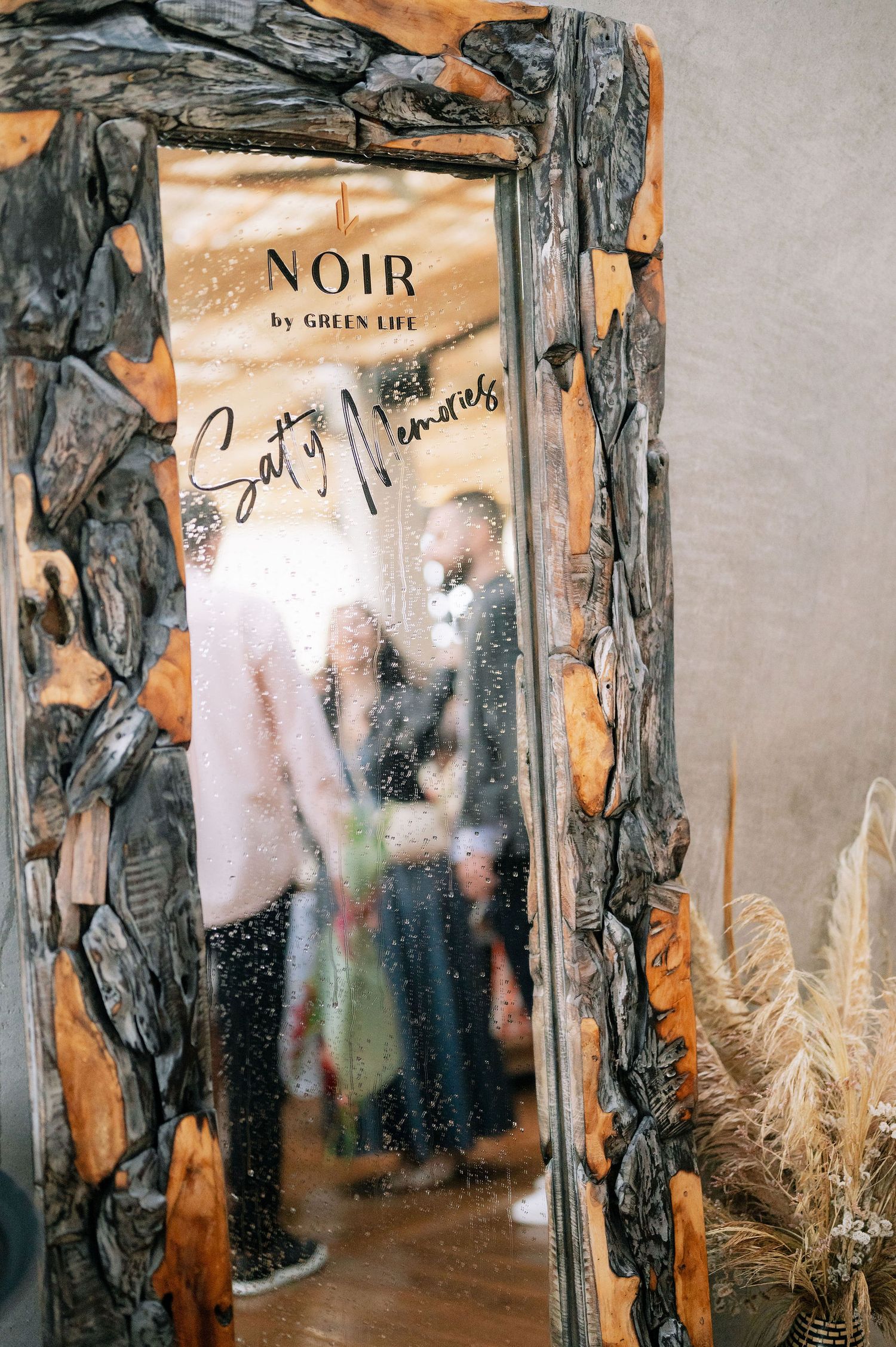 Art installation with distressed wooden frames and mirrors in a gallery space.