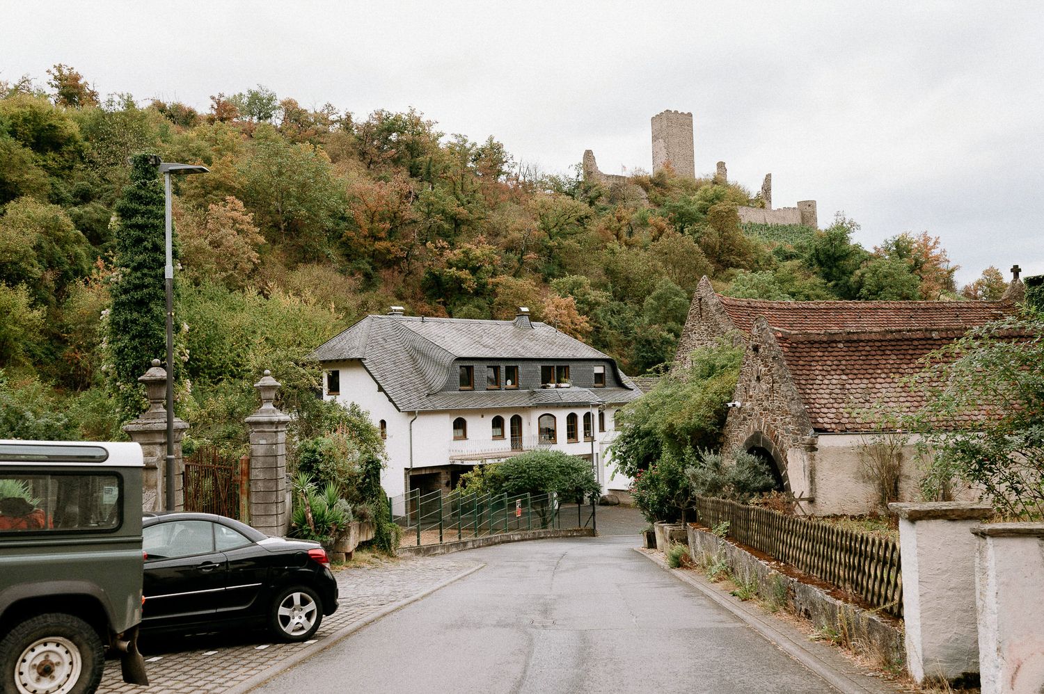Scenic street view with historic buildings and autumn trees in a German village.