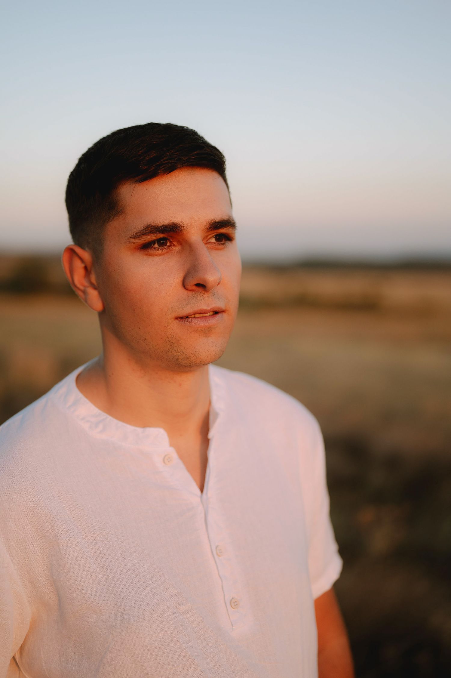 Portrait shots at sunset showing a person in a white henley shirt against a warm golden landscape.
