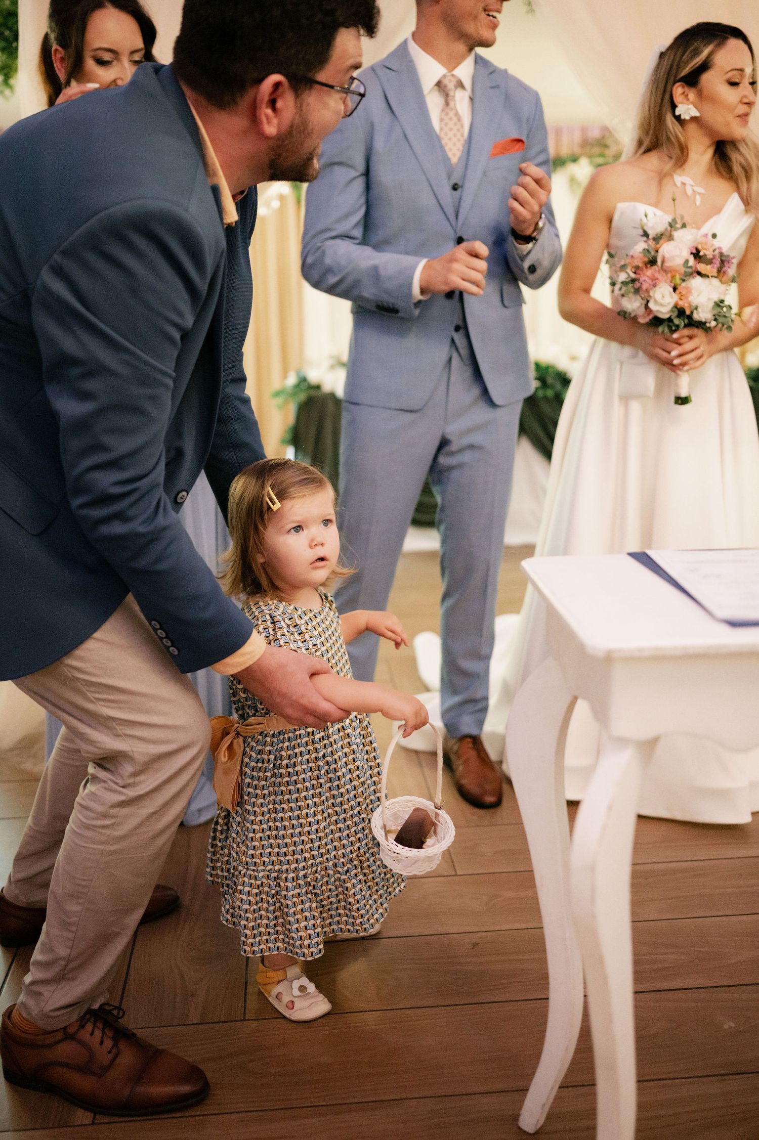 A sequence of photos showing a young girl in a polka dot dress dancing with an adult at a wedding reception.