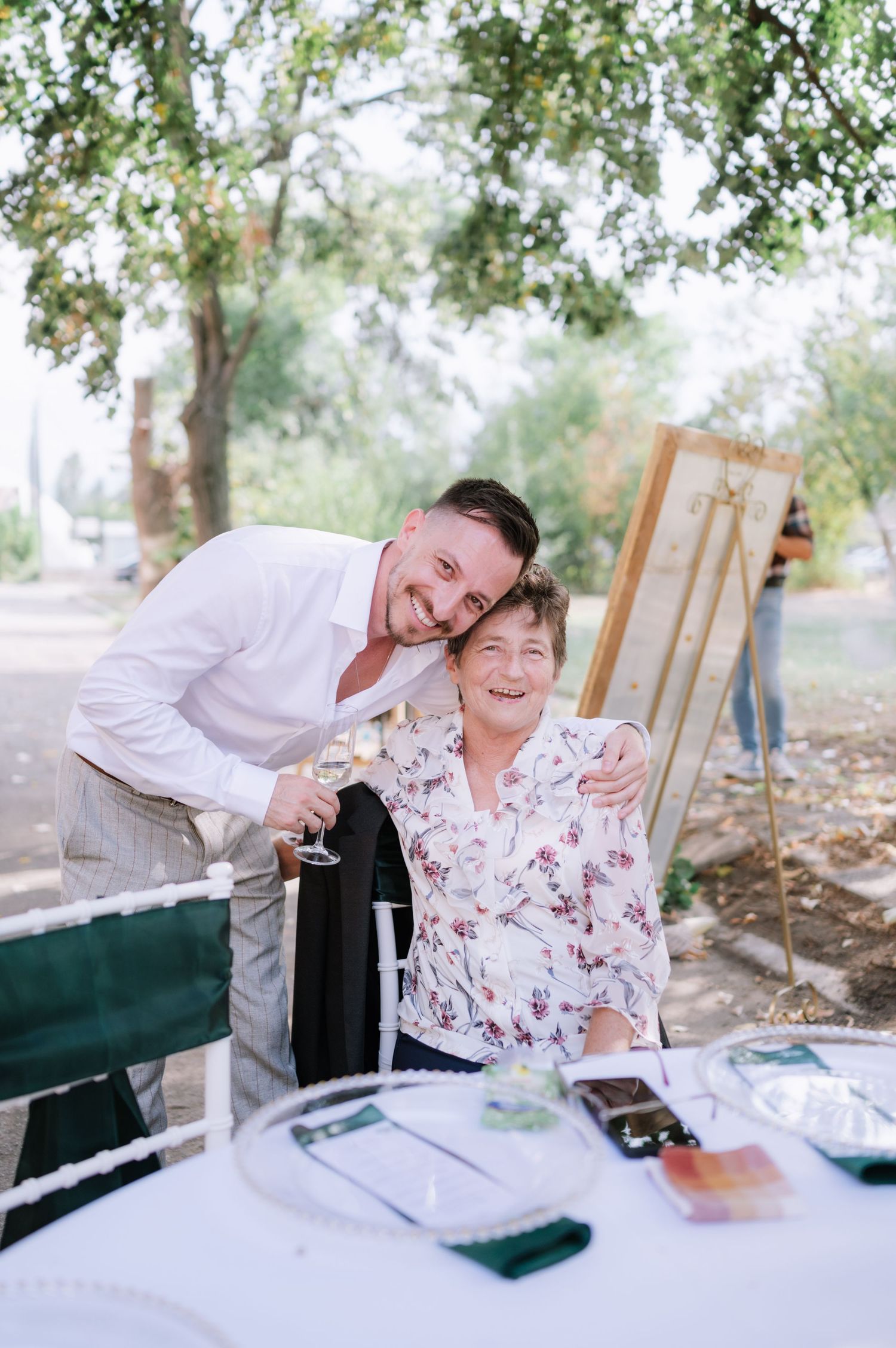 A sequence of four candid moments showing laughter and joy at an outdoor event with a white table setting.