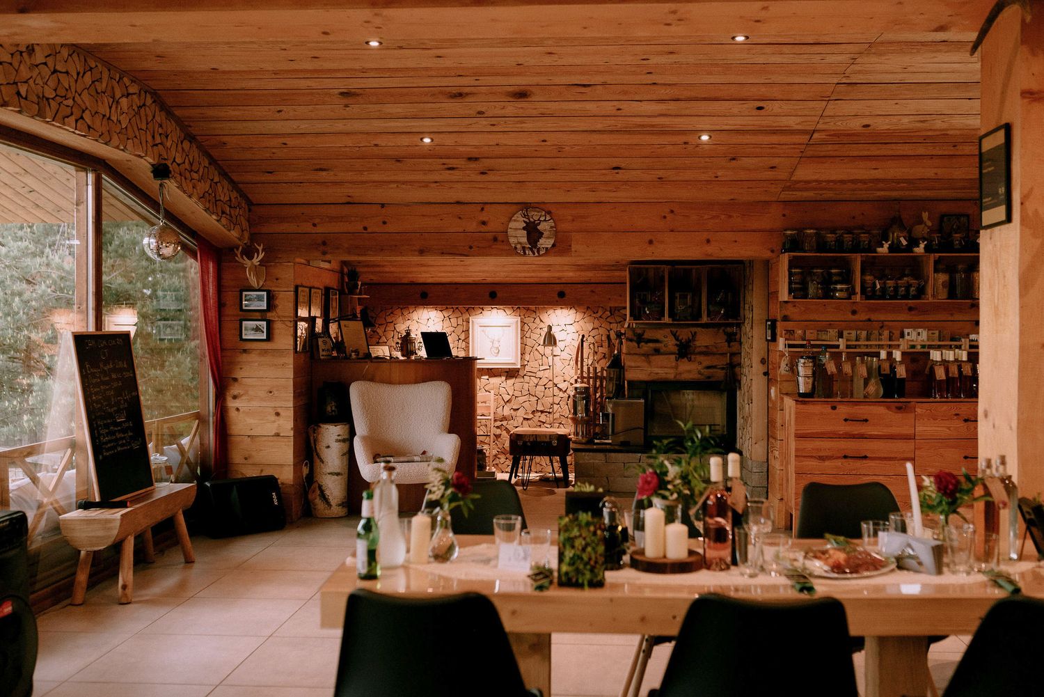 Interior panorama of a wooden barn wedding venue with exposed beams and ambient lighting.