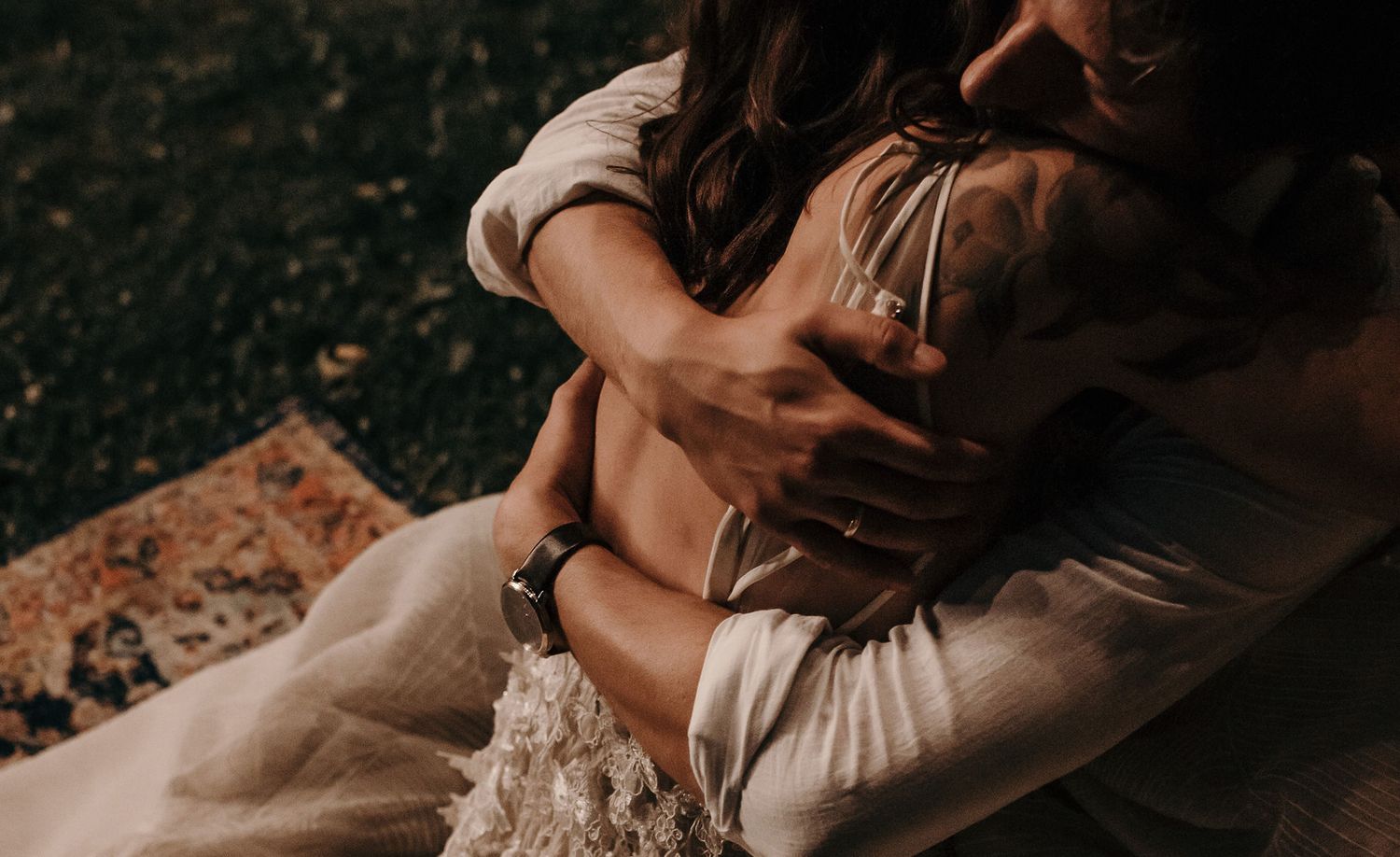 A romantic wedding moment captured in moody lighting with warm tones and intimate atmosphere.
