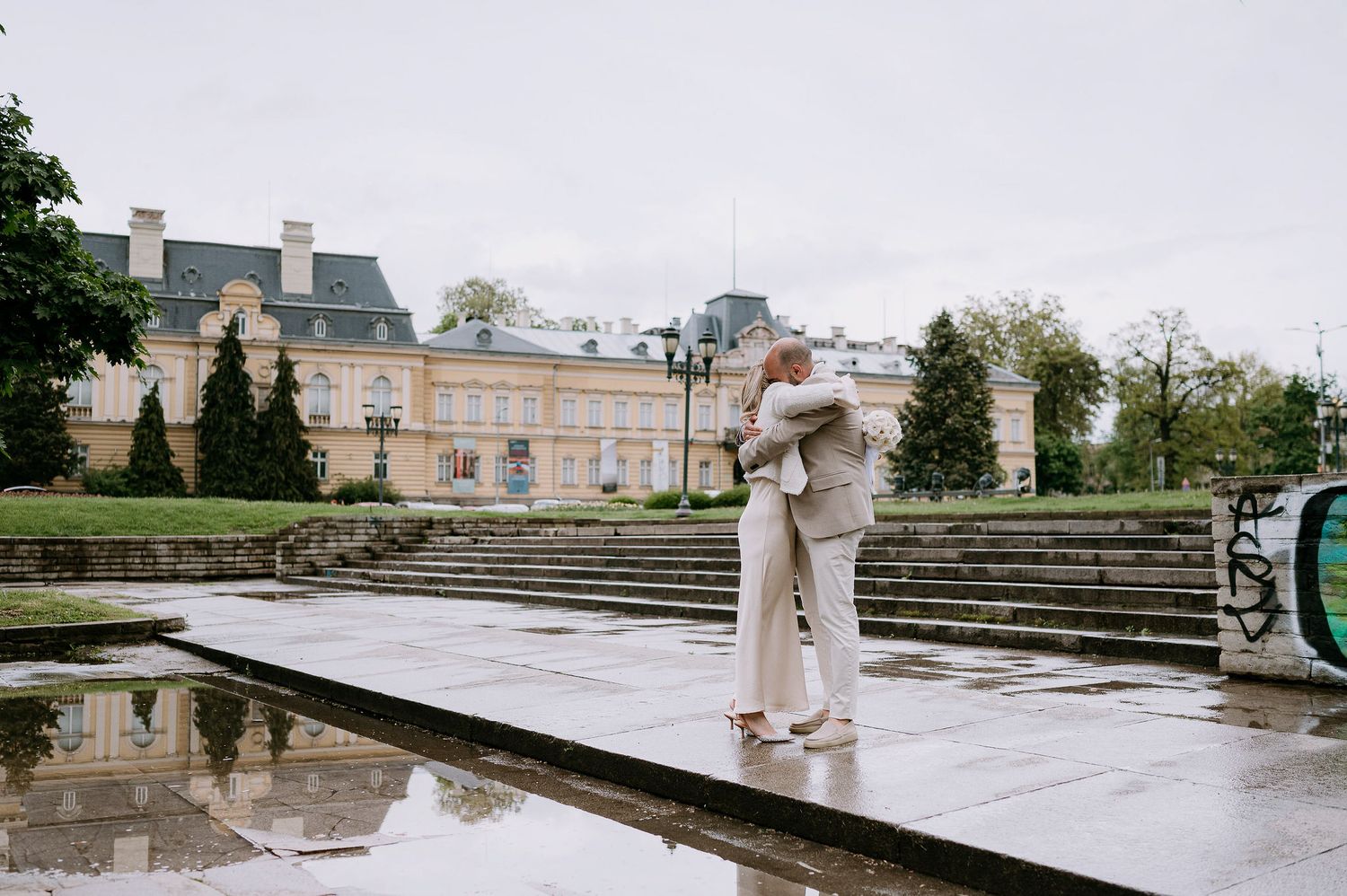 Wide architectural shot of stone steps and reflecting pool at historic venue.
