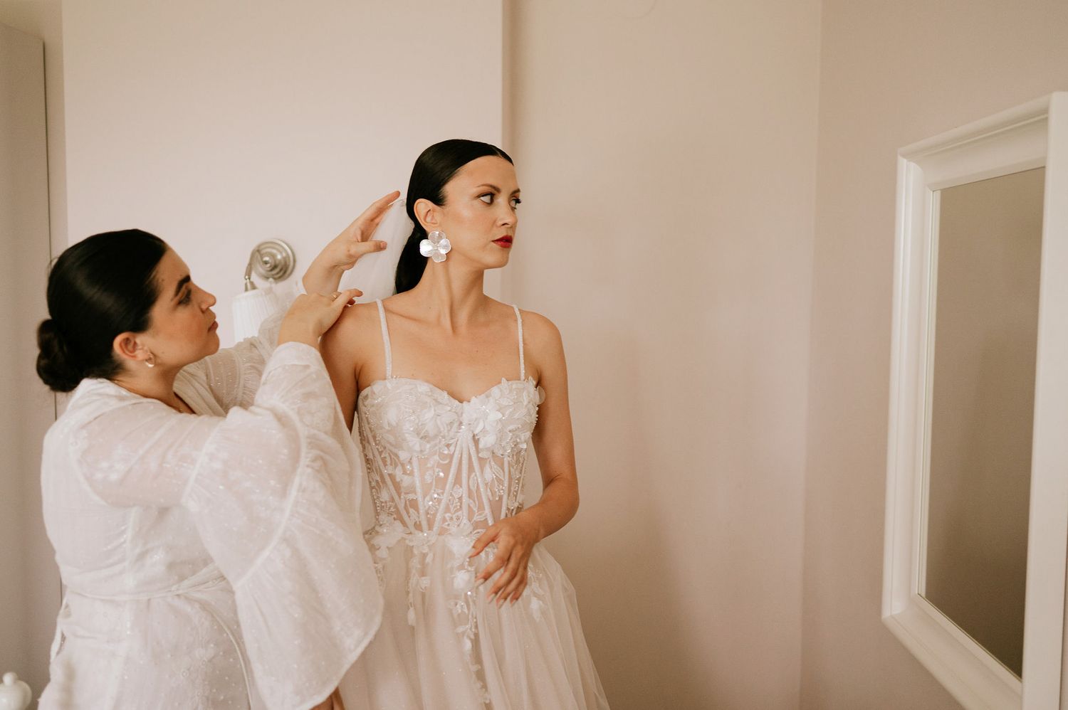 Elegant bridal preparations showing delicate details of a white wedding dress.