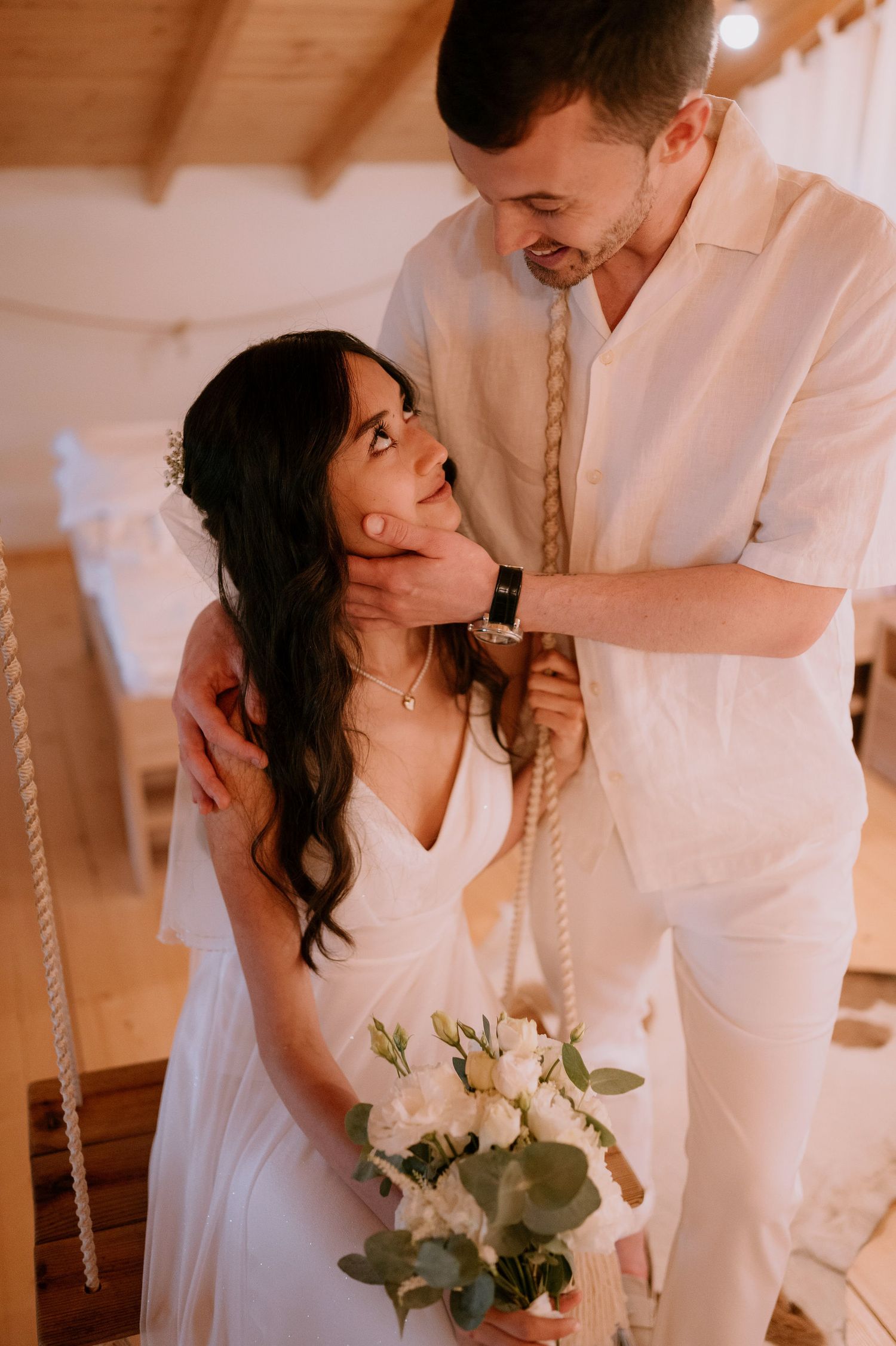 Intimate wedding portraits captured in warm lighting with rustic wooden interior details.