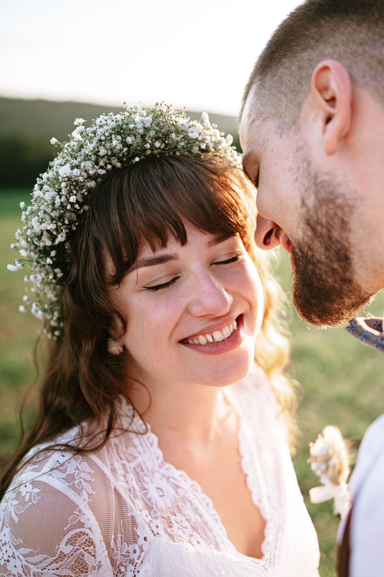 Close-up wedding portraits showing genuine laughter and joy during sunset photo session.