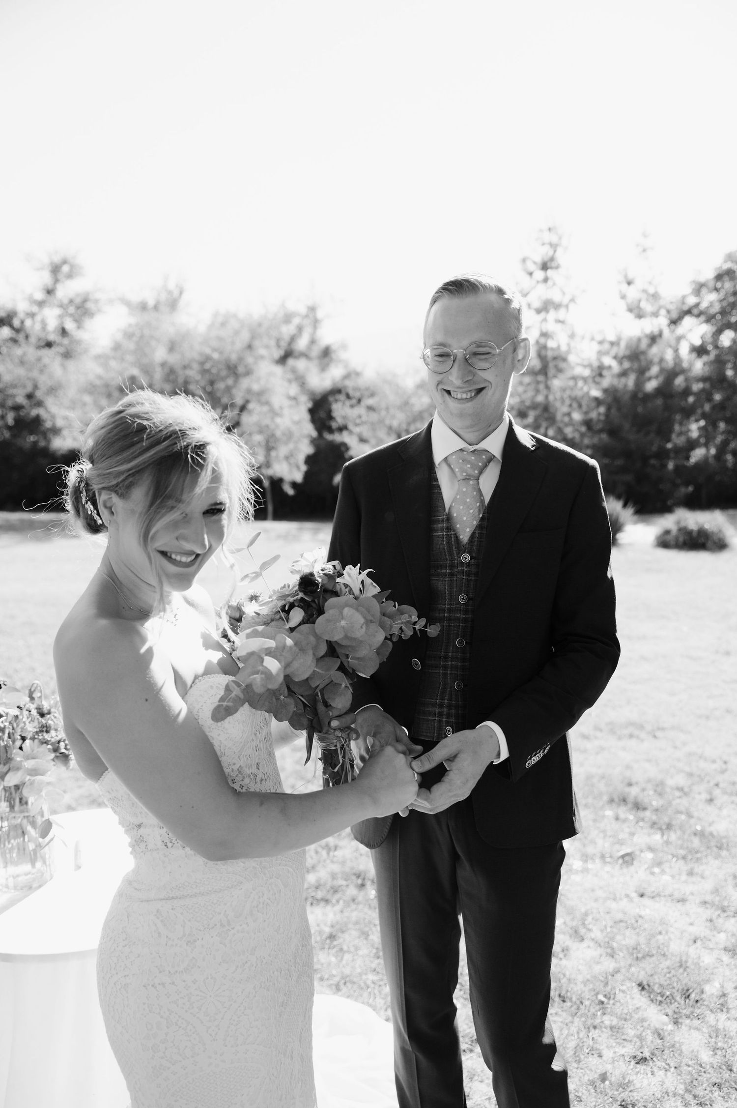 Series of black and white photos showing happy moments between newlyweds outdoors.