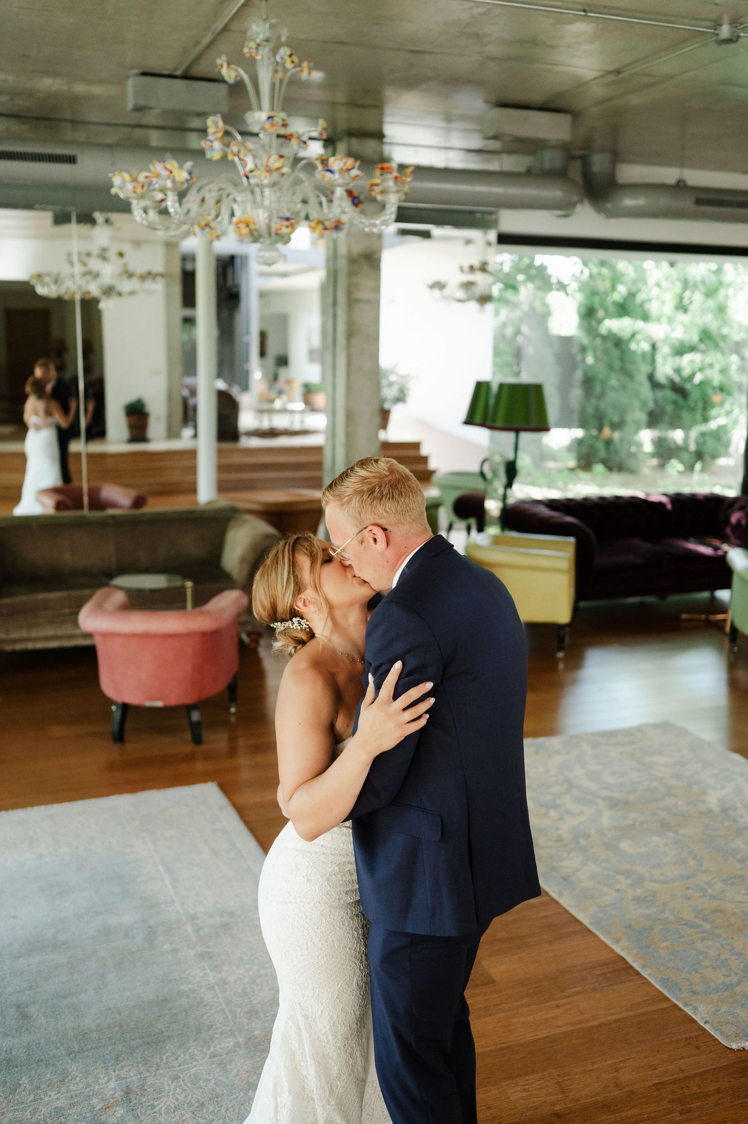 Newlyweds embrace during an intimate first dance moment in a beautifully decorated venue.