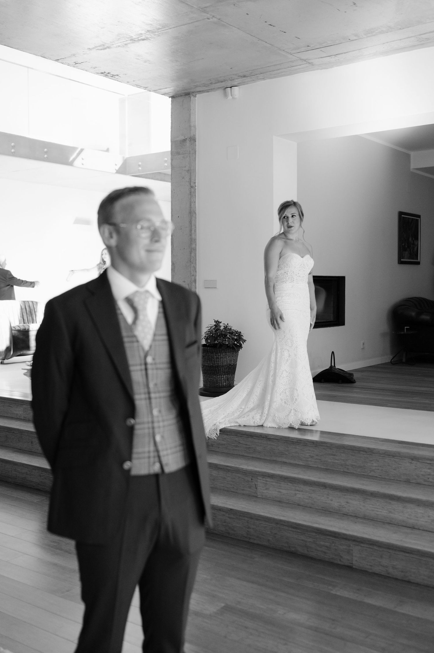 A spacious room with hardwood floors and steps features formal attire on display.