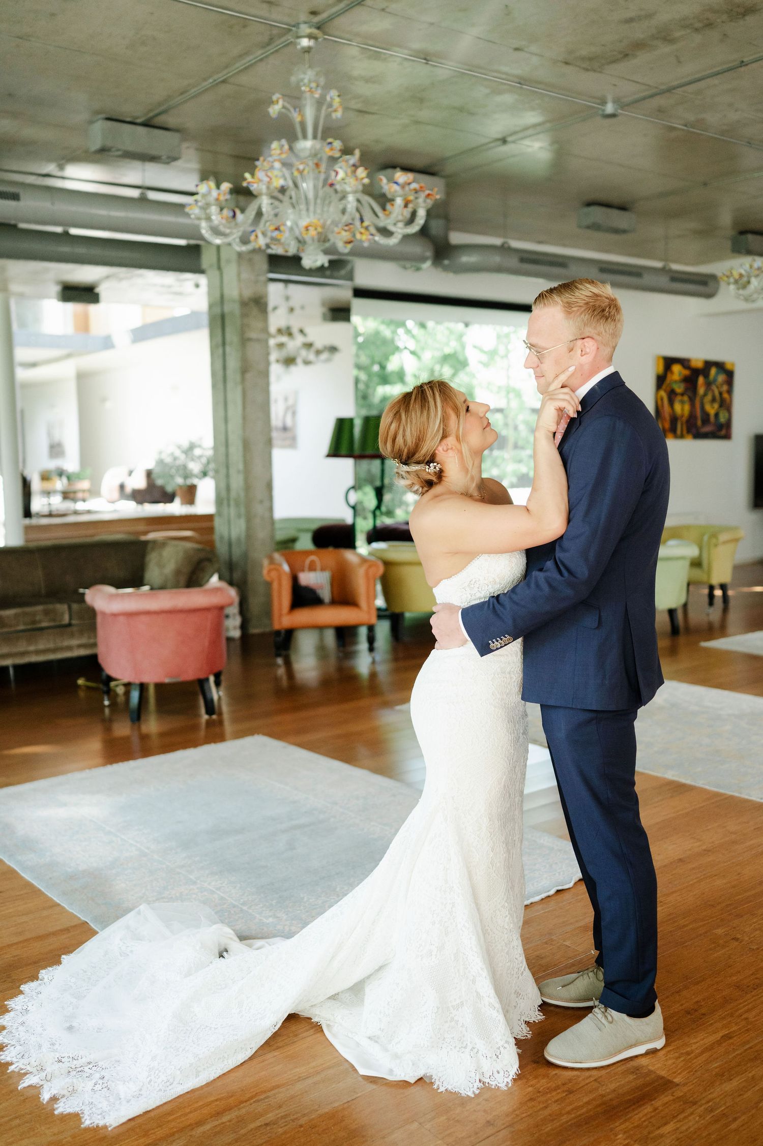 Wedding couple's first look captured in sequence on elegant hardwood floor.
