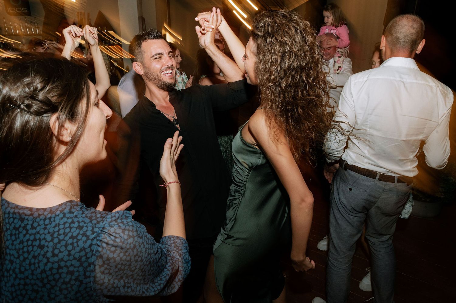 Candid moments of people dancing and celebrating at a lively indoor party.