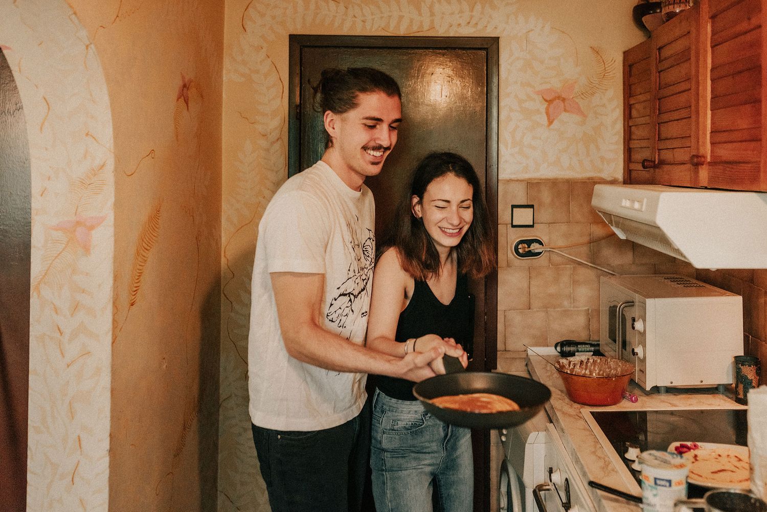 A series of photos showing people cooking and preparing food together in a cozy home kitchen.