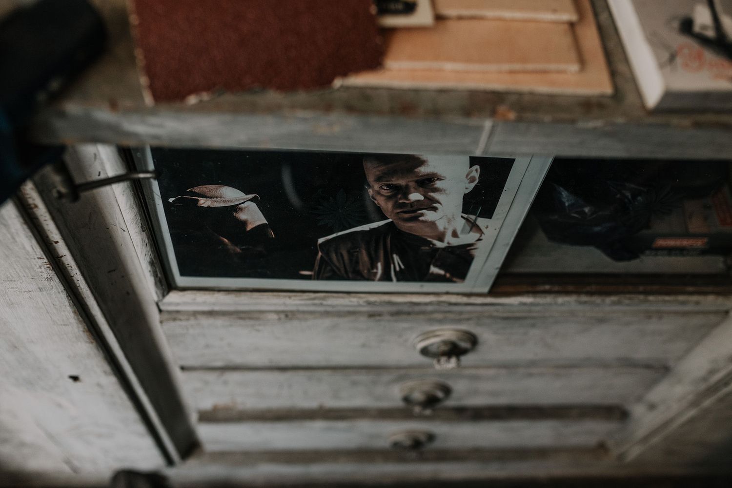 Dusty wooden shelves and storage compartments in an old workshop setting.